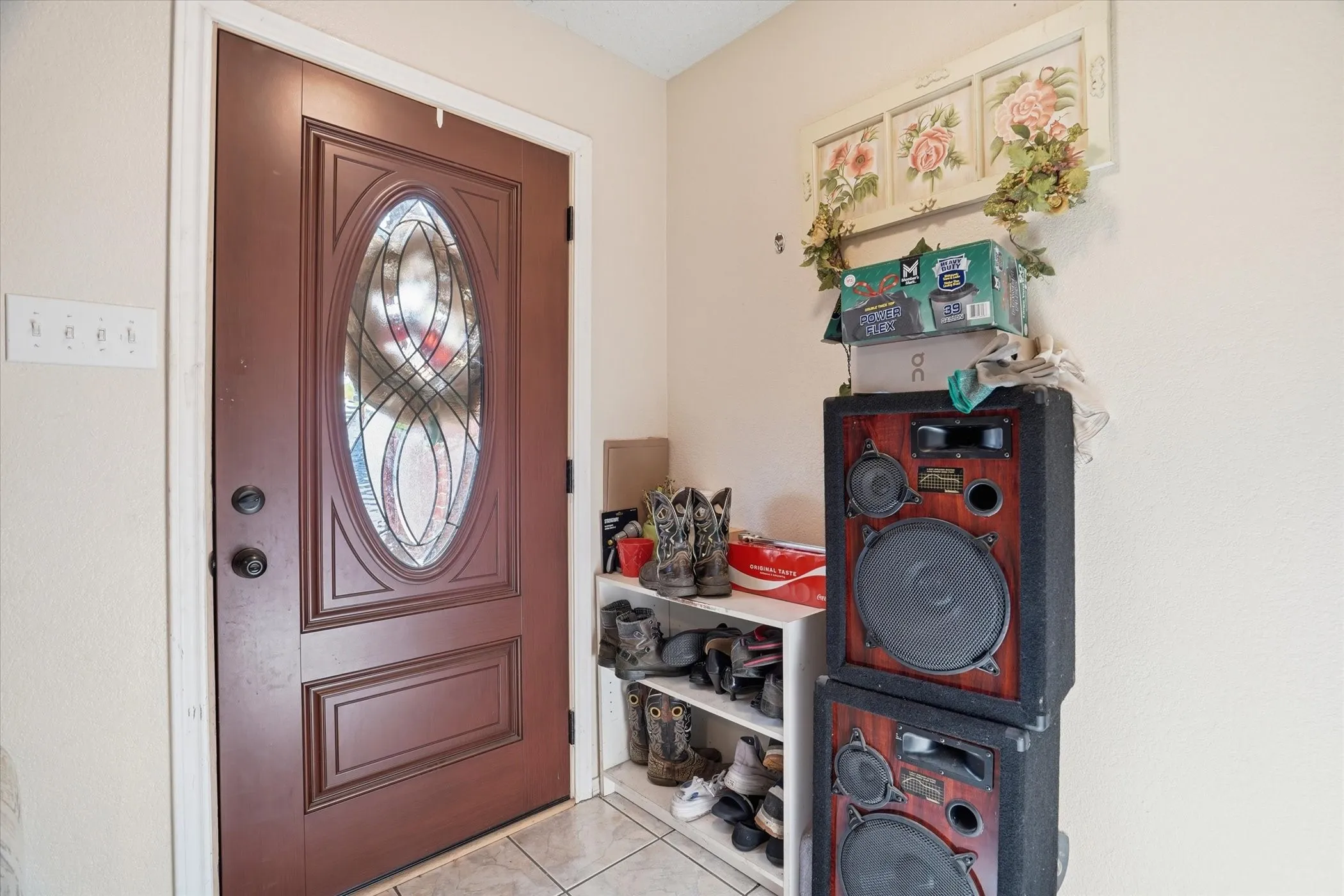 Foyer entrance featuring light tile patterned flooring