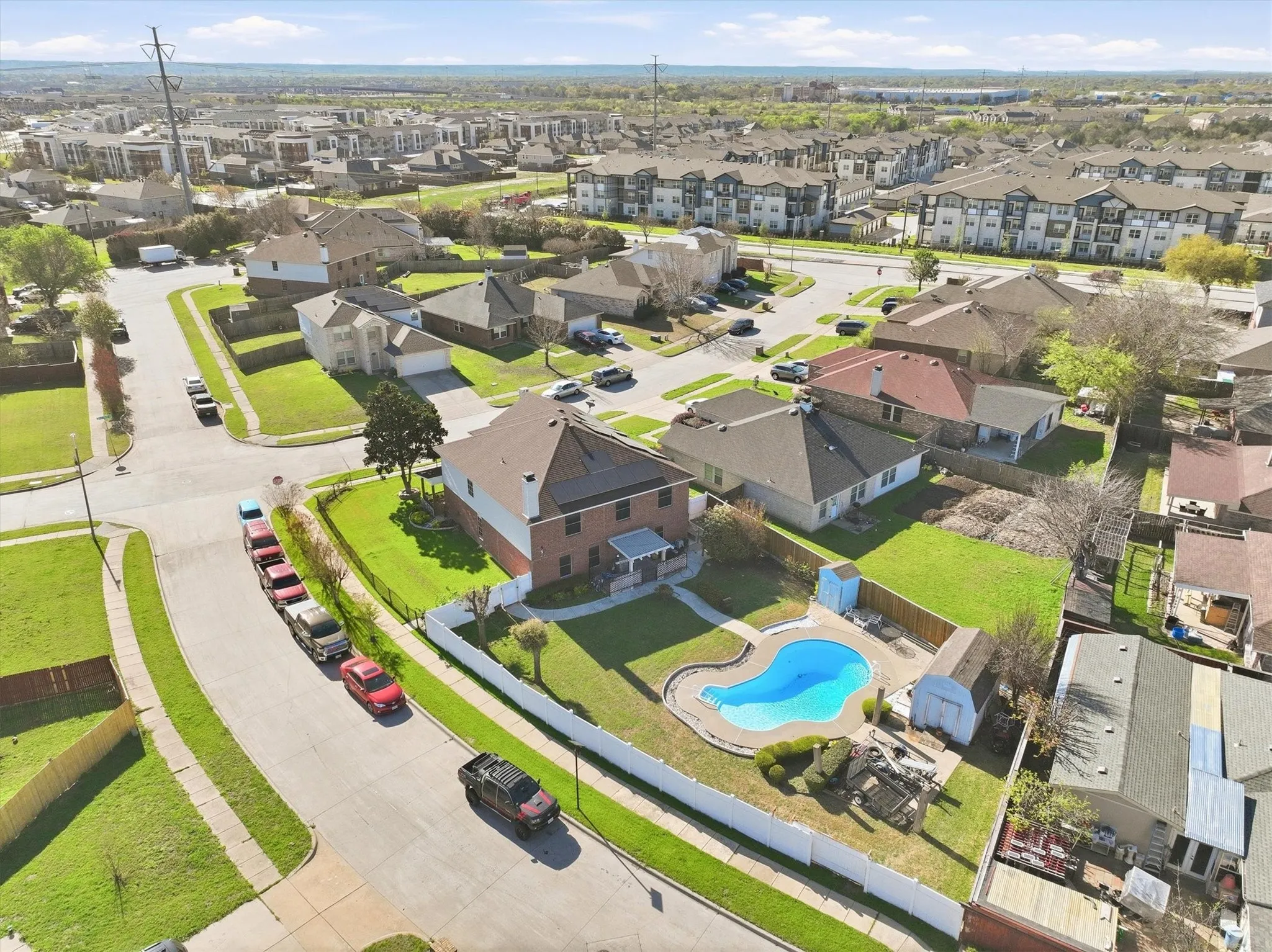 Aerial view of residential area featuring a pool area