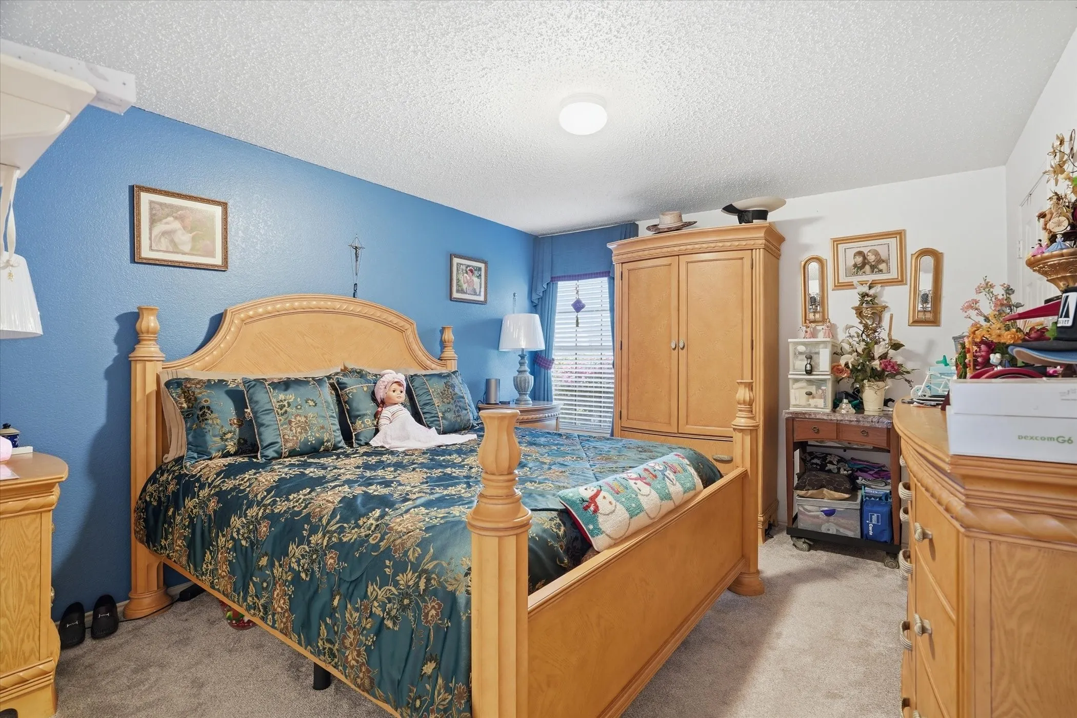 Bedroom with light carpet and a textured ceiling