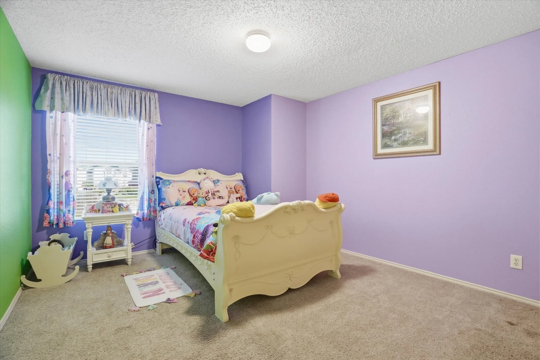 Carpeted bedroom featuring a textured ceiling and baseboards