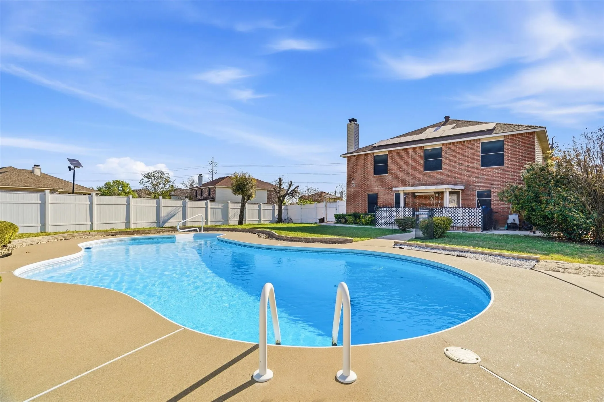 View of swimming pool featuring a fenced backyard and patio surround