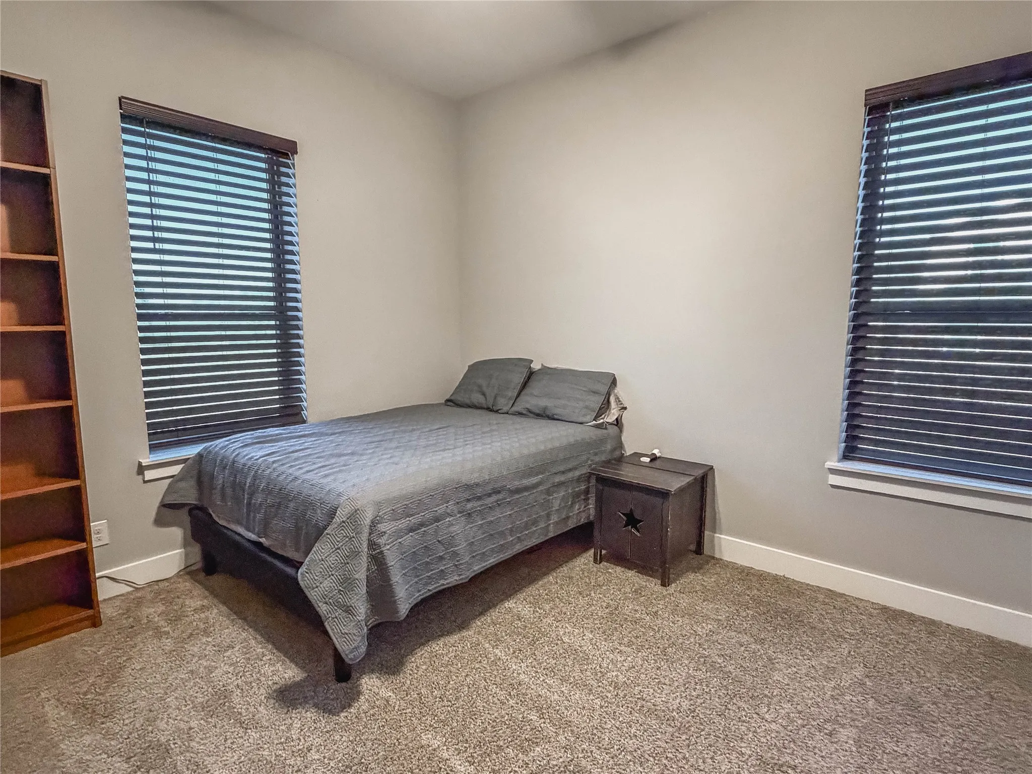 Carpeted bedroom featuring baseboards