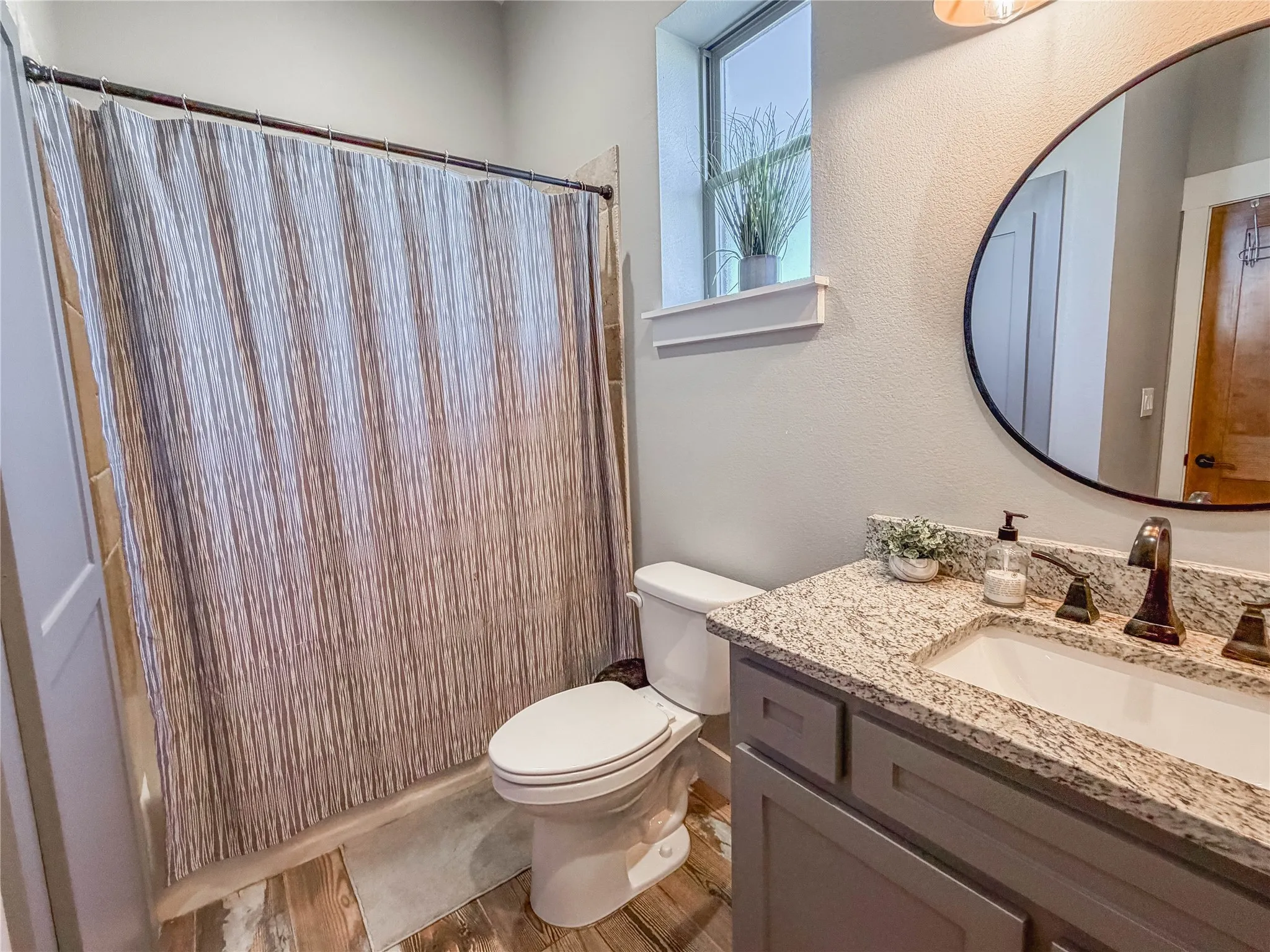 Bathroom featuring vanity and curtained shower