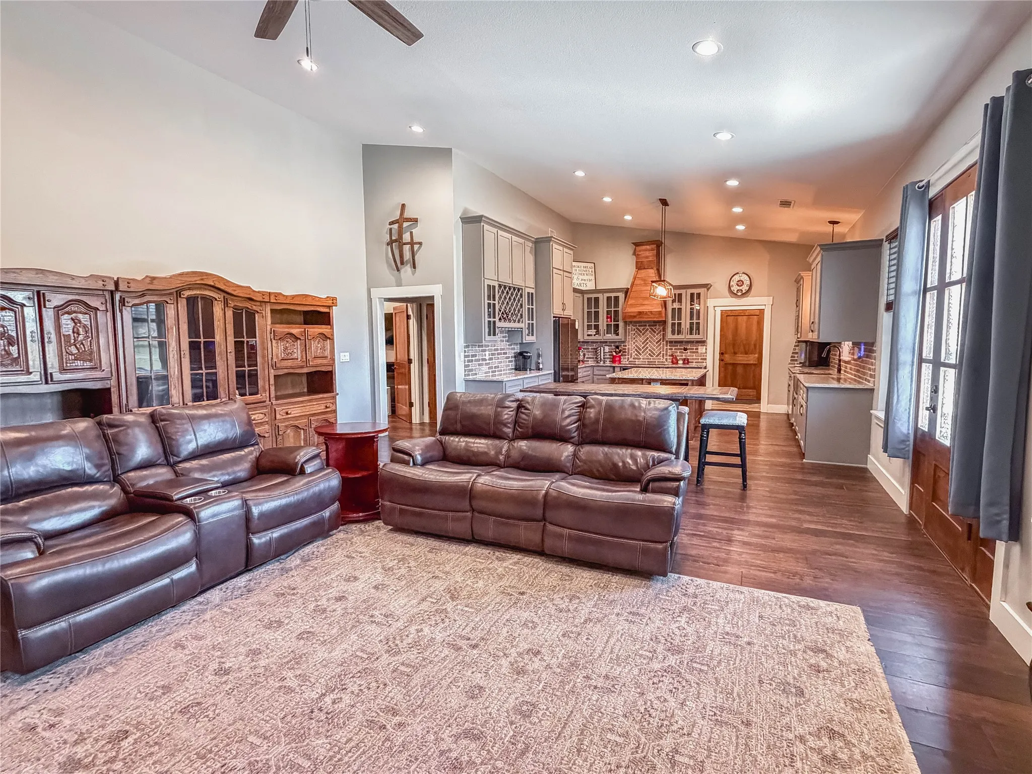 Living area with dark wood-style flooring, recessed lighting, and a ceiling fan