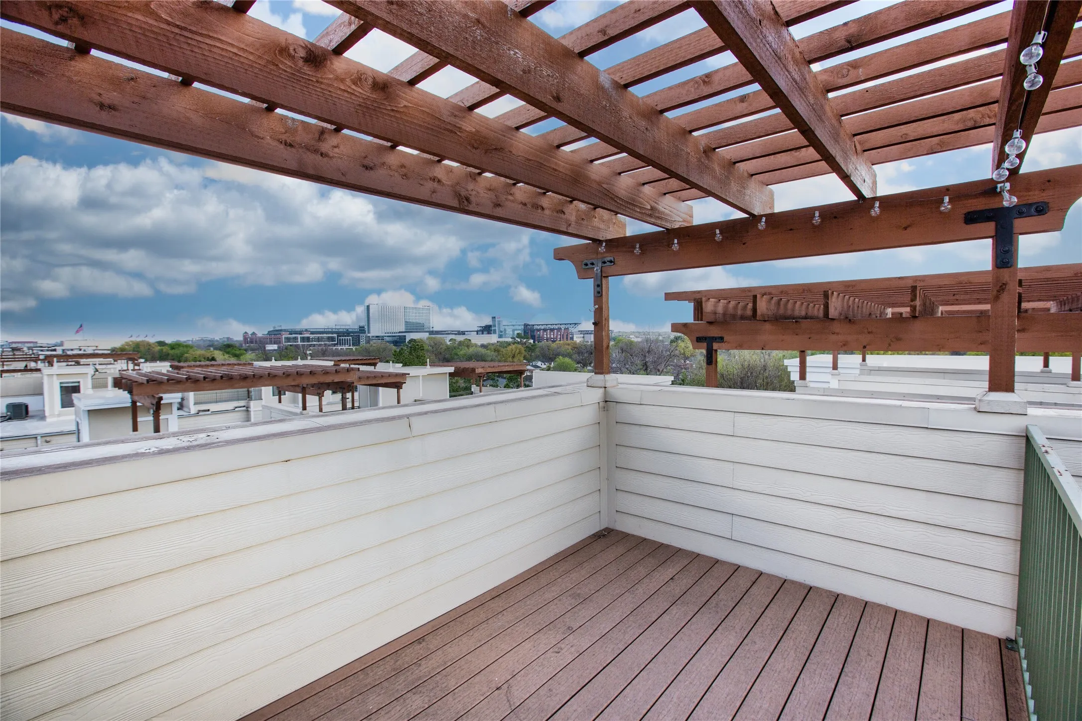 Rooftop patio featuring a wood-finish pergola,