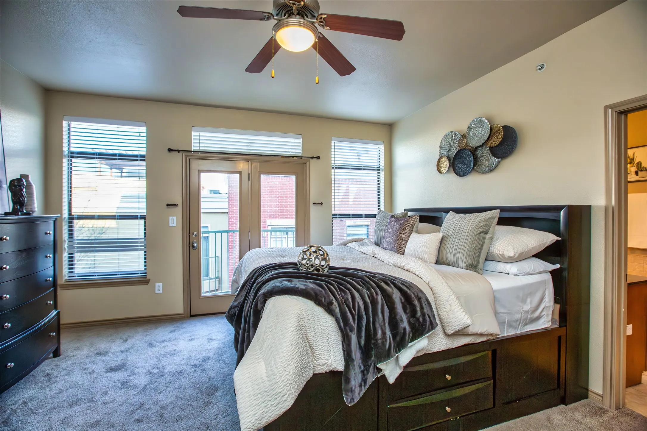 Carpeted bedroom featuring access to outside and a ceiling fan