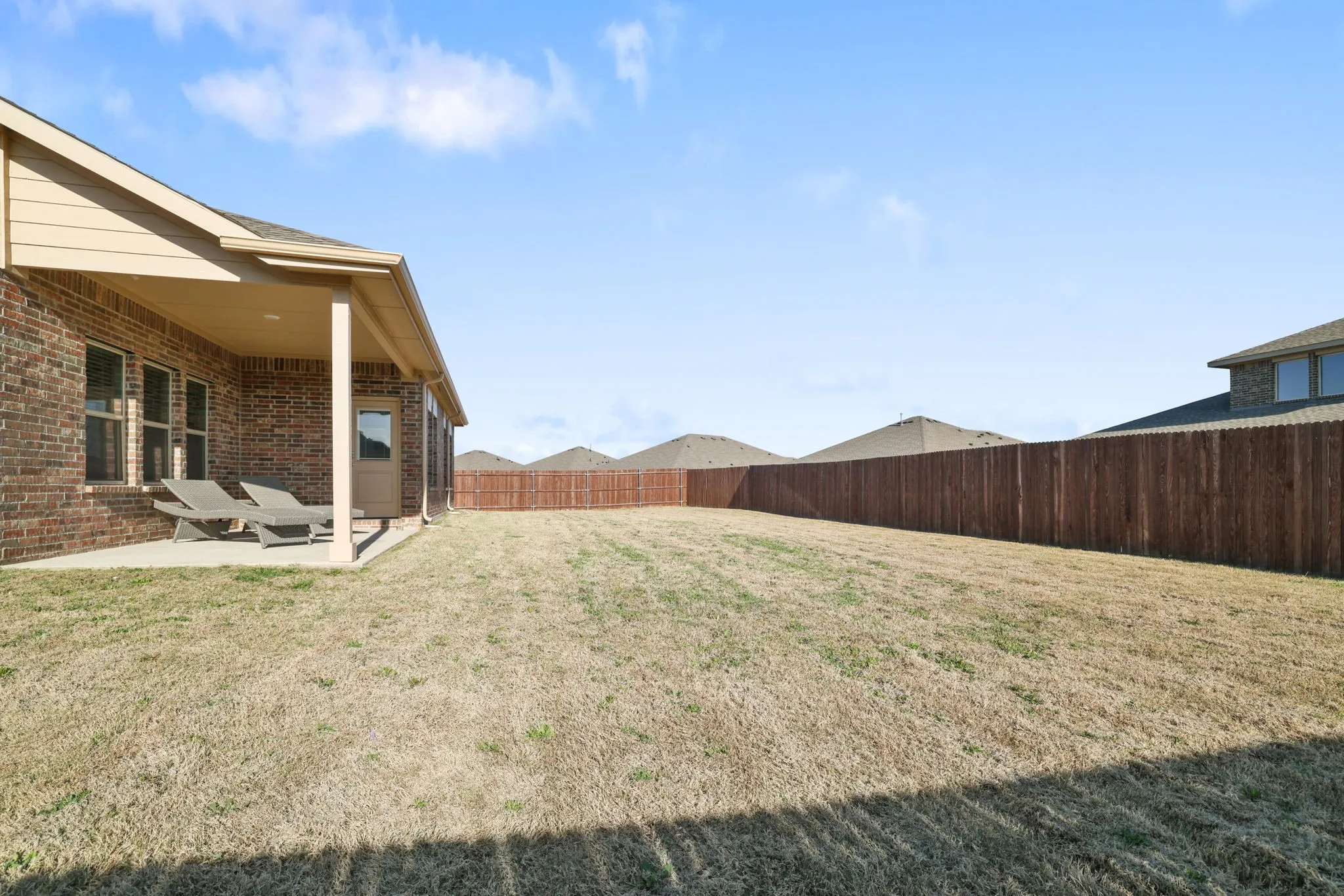 Fenced backyard with a patio area