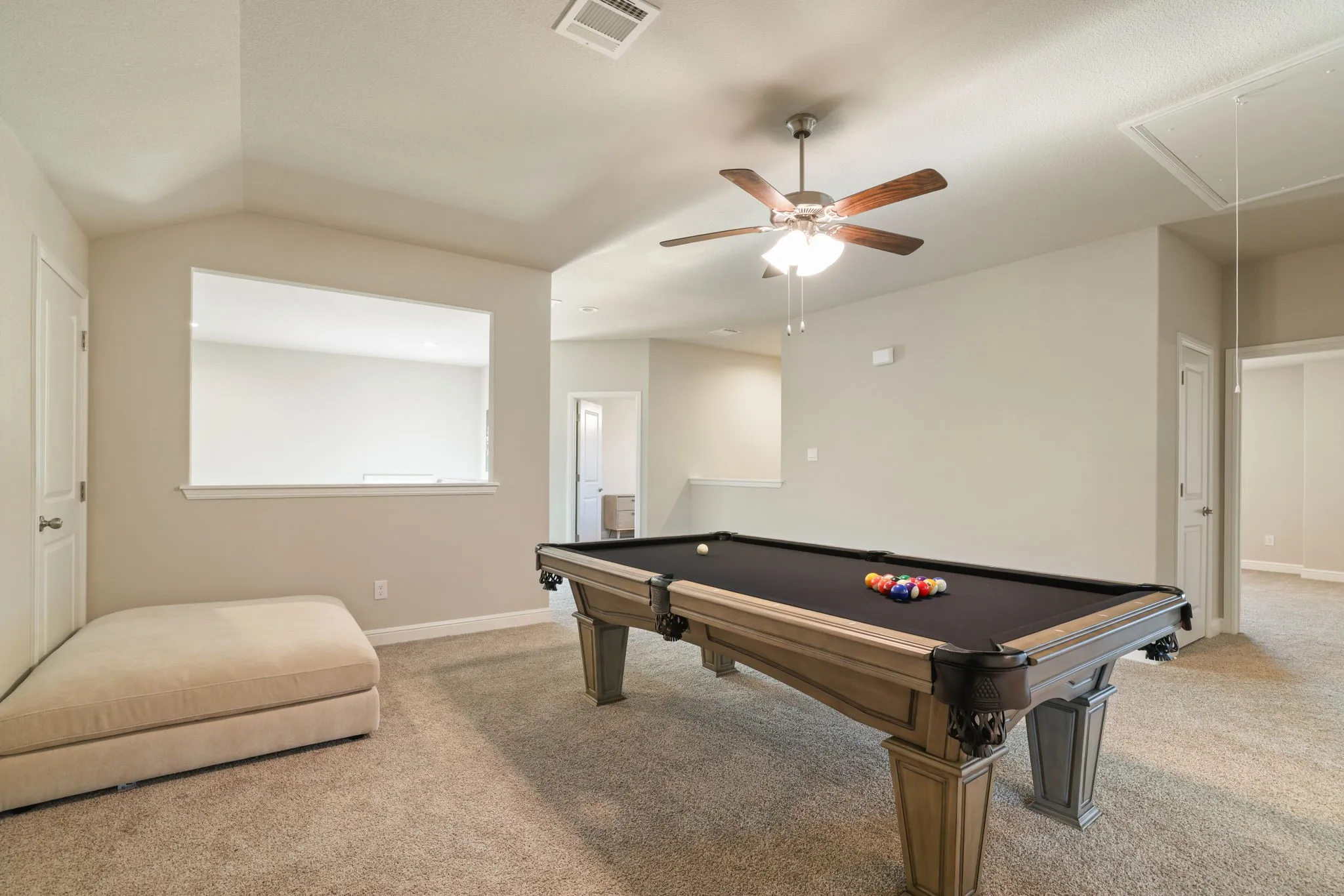 Rec room with carpet, vaulted ceiling, billiards table, and ceiling fan