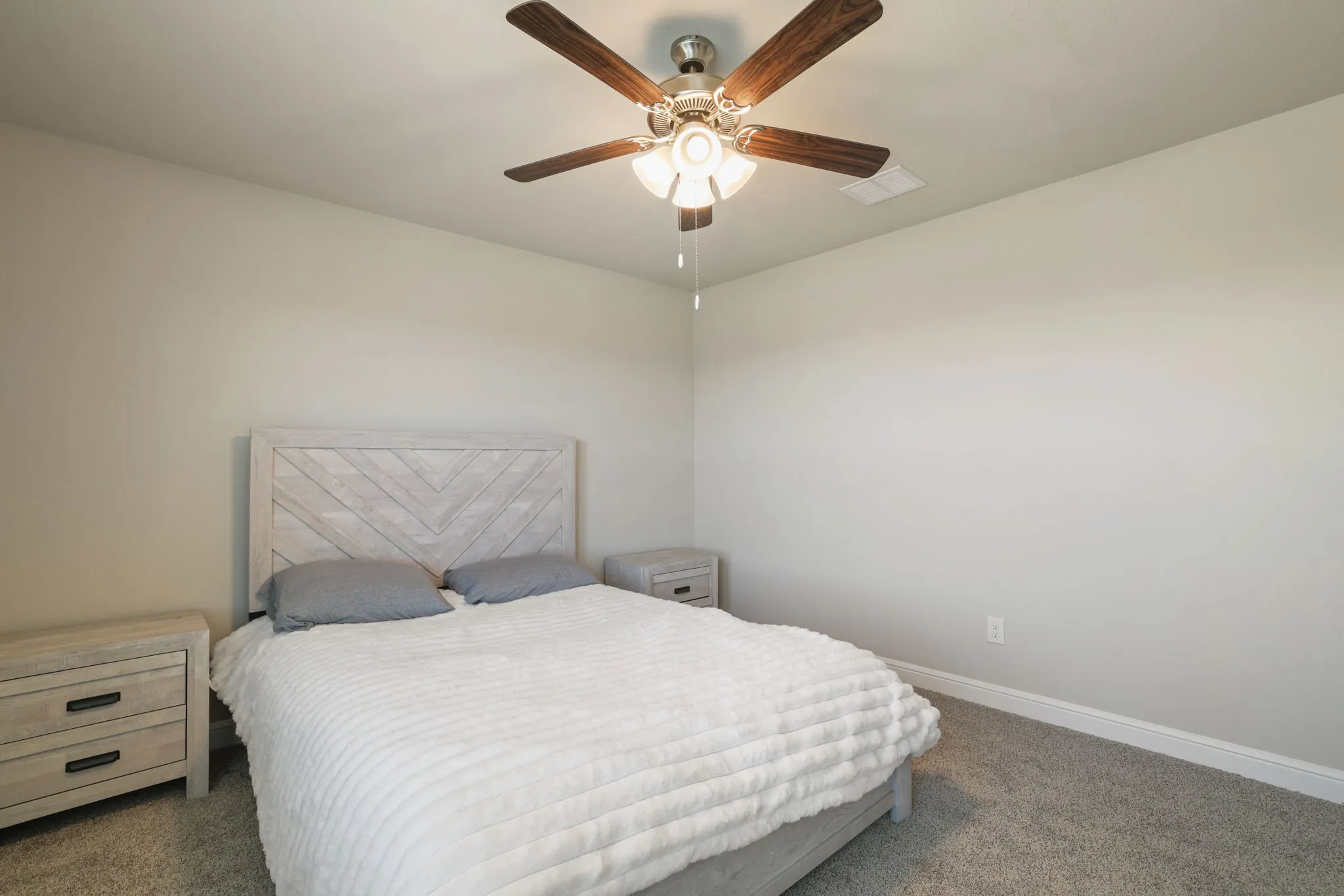 Bedroom featuring dark carpet and a ceiling fan