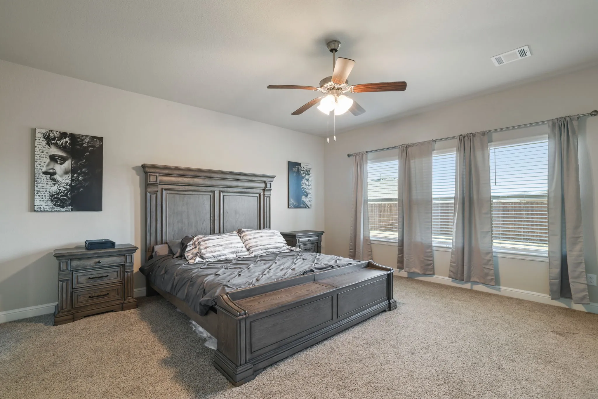Bedroom featuring light carpet and ceiling fan