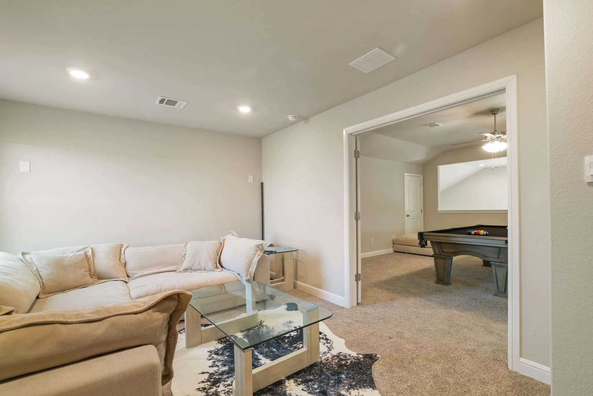 Living room featuring light colored carpet, ceiling fan, recessed lighting, and billiards