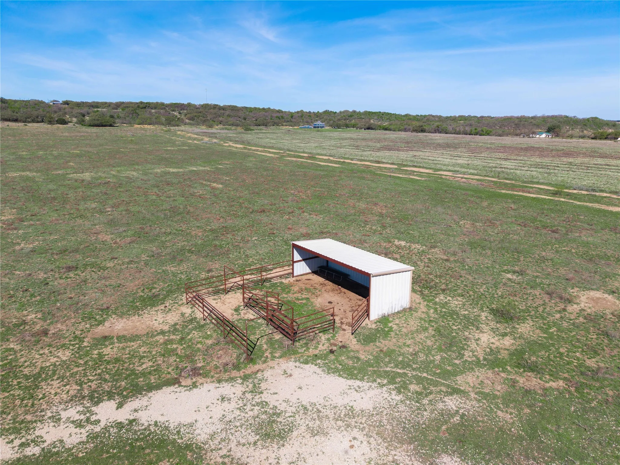 View of property's community with an outdoor structure, a pole building, and a view of rural / pastoral area