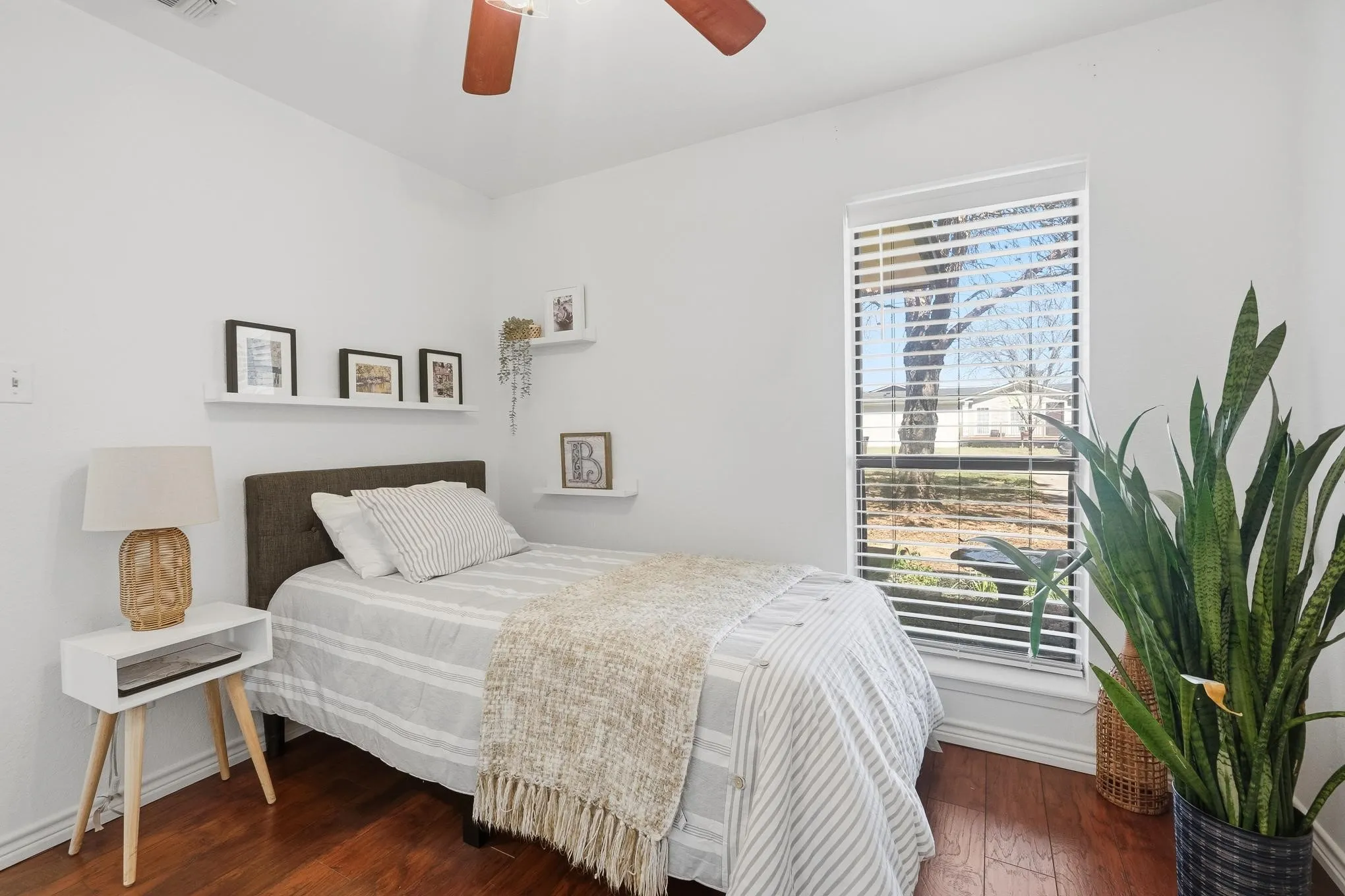 Bedroom featuring dark wood-style floors and a ceiling fan