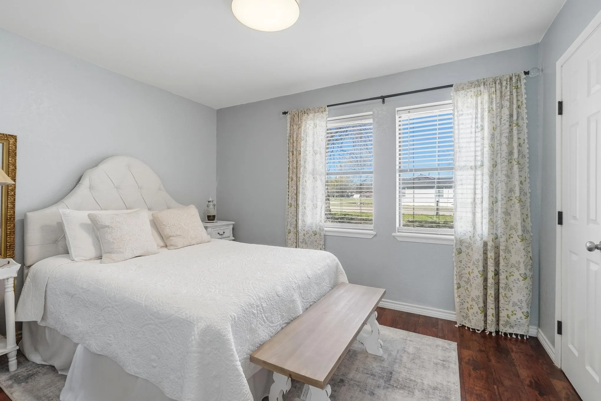 Bedroom featuring dark wood finished floors and baseboards