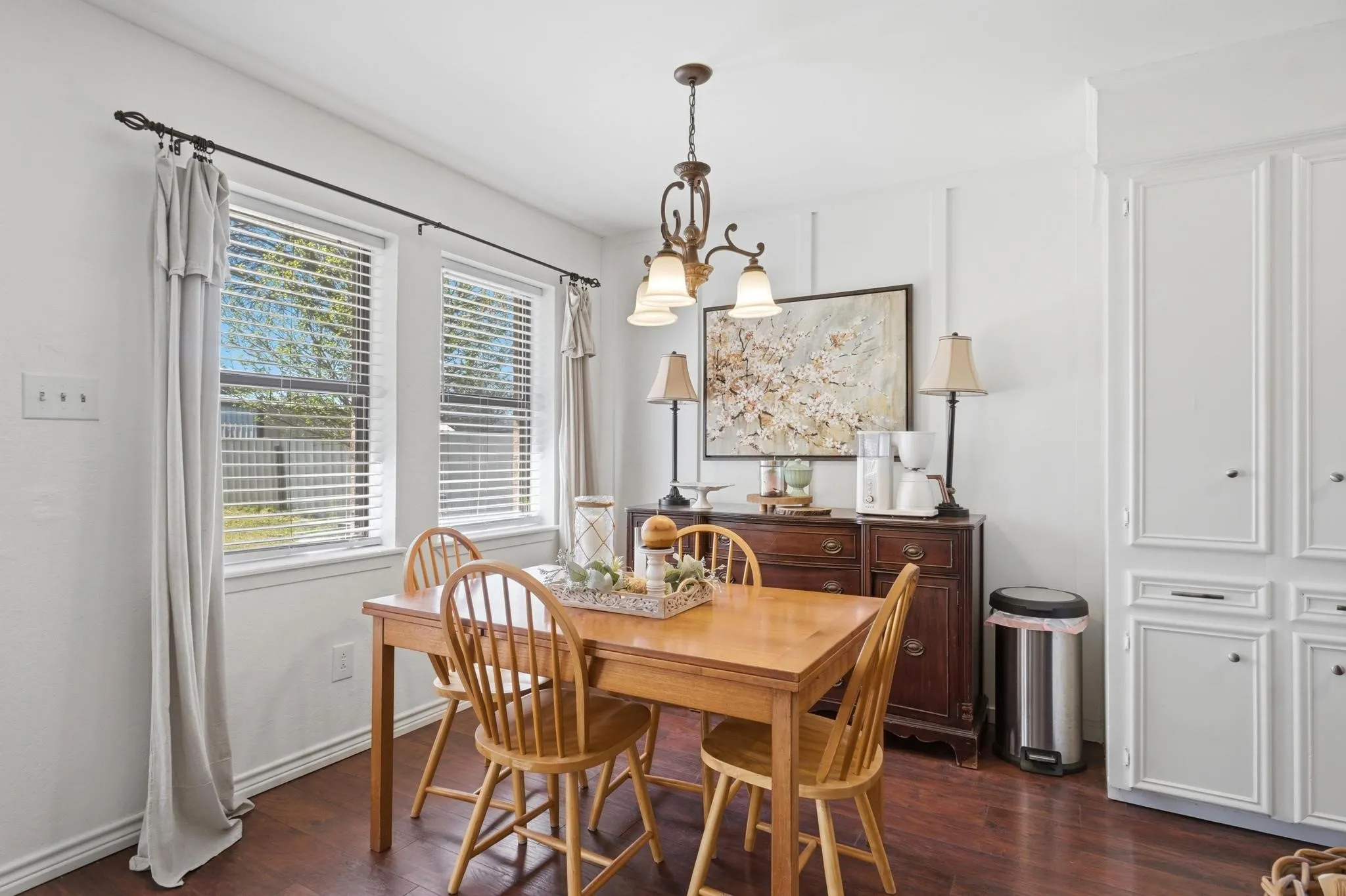Dining area with dark wood-style flooring