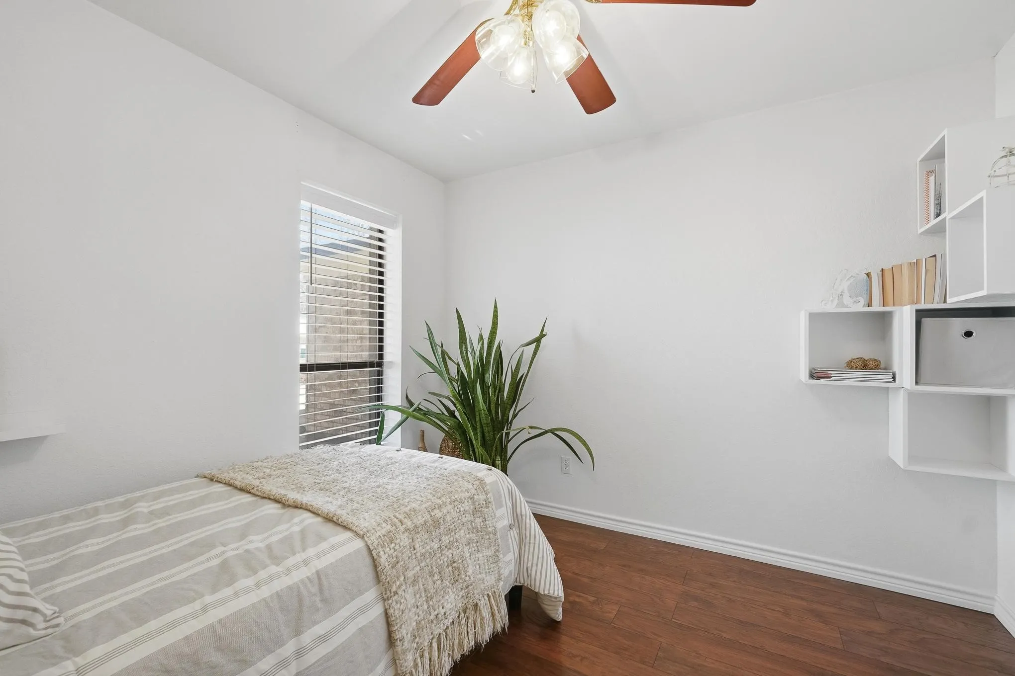 Bedroom with dark wood-style flooring and ceiling fan