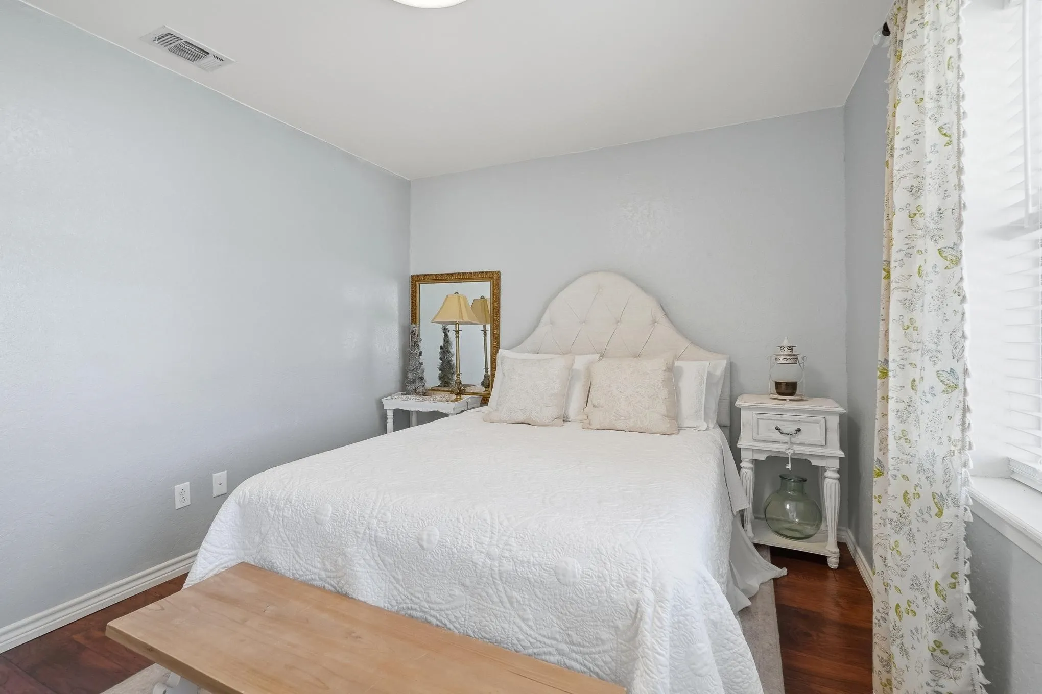 Bedroom with dark wood-style floors and baseboards