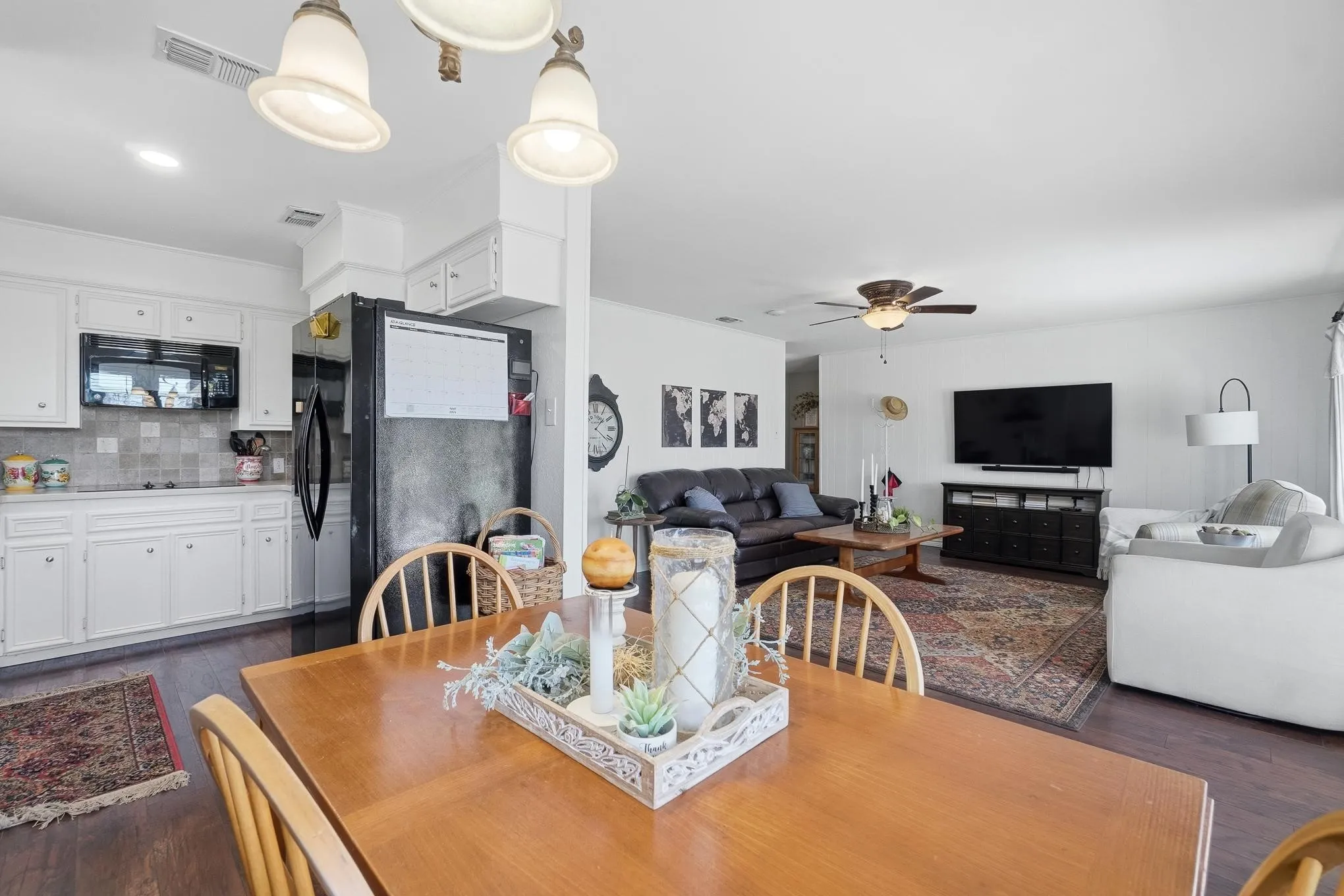 Dining room featuring dark wood-style flooring and a ceiling fan