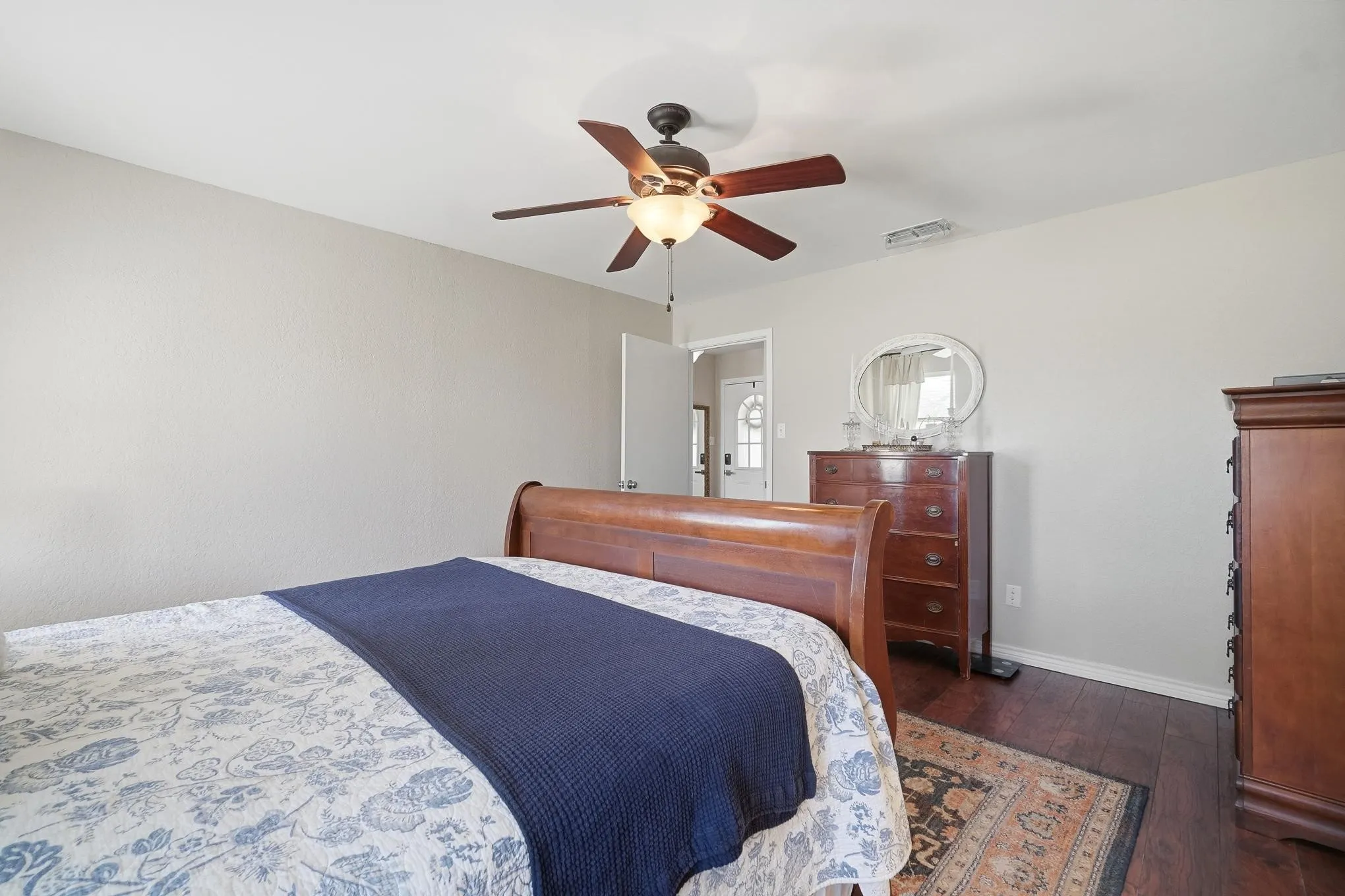 Bedroom featuring dark wood-style floors and ceiling fan