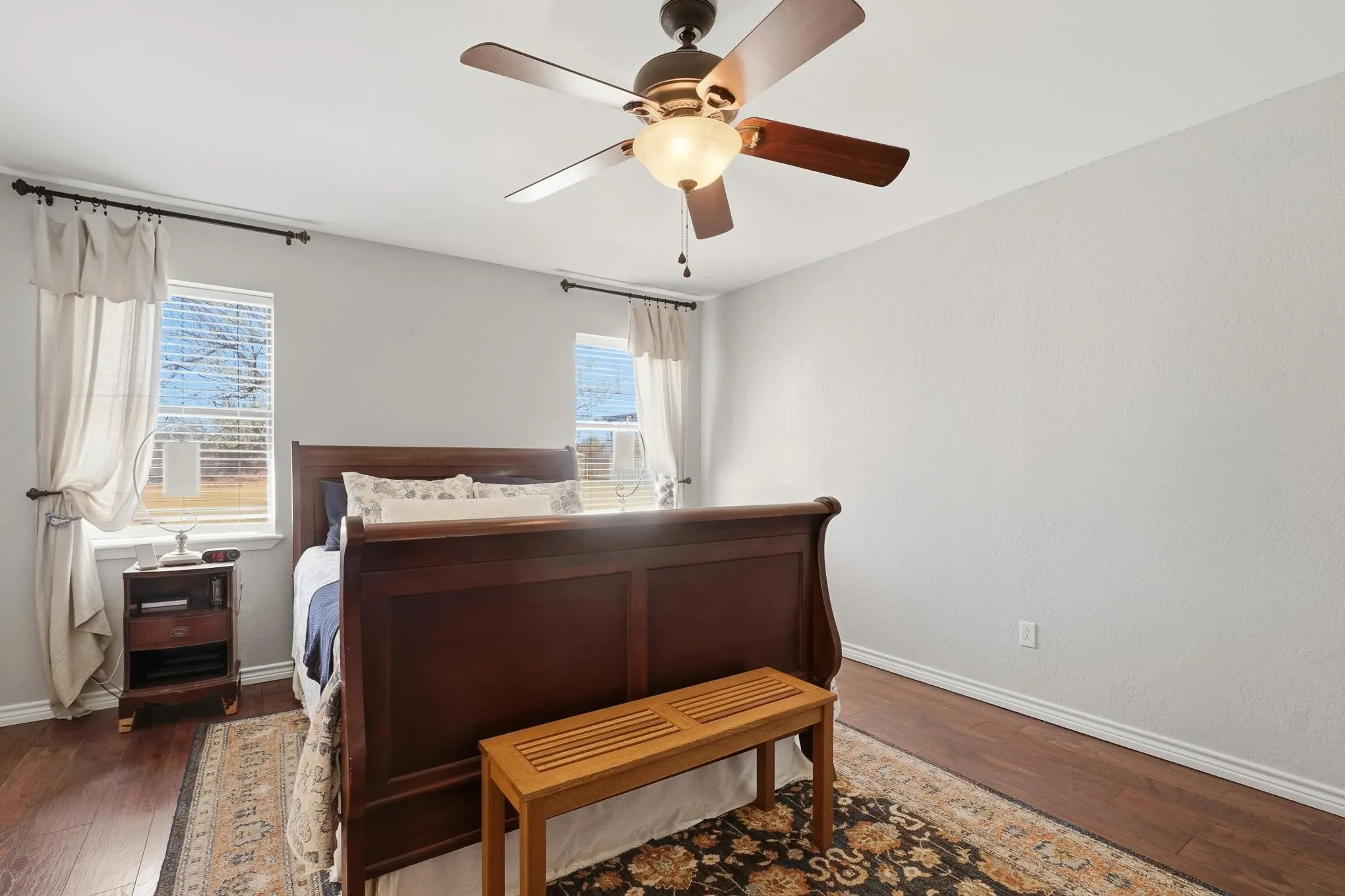 Bedroom with wood finished floors and ceiling fan