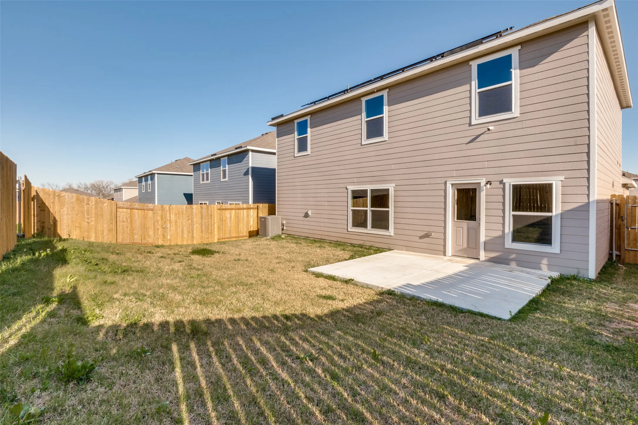 Rear view of house with a patio and a fenced backyard