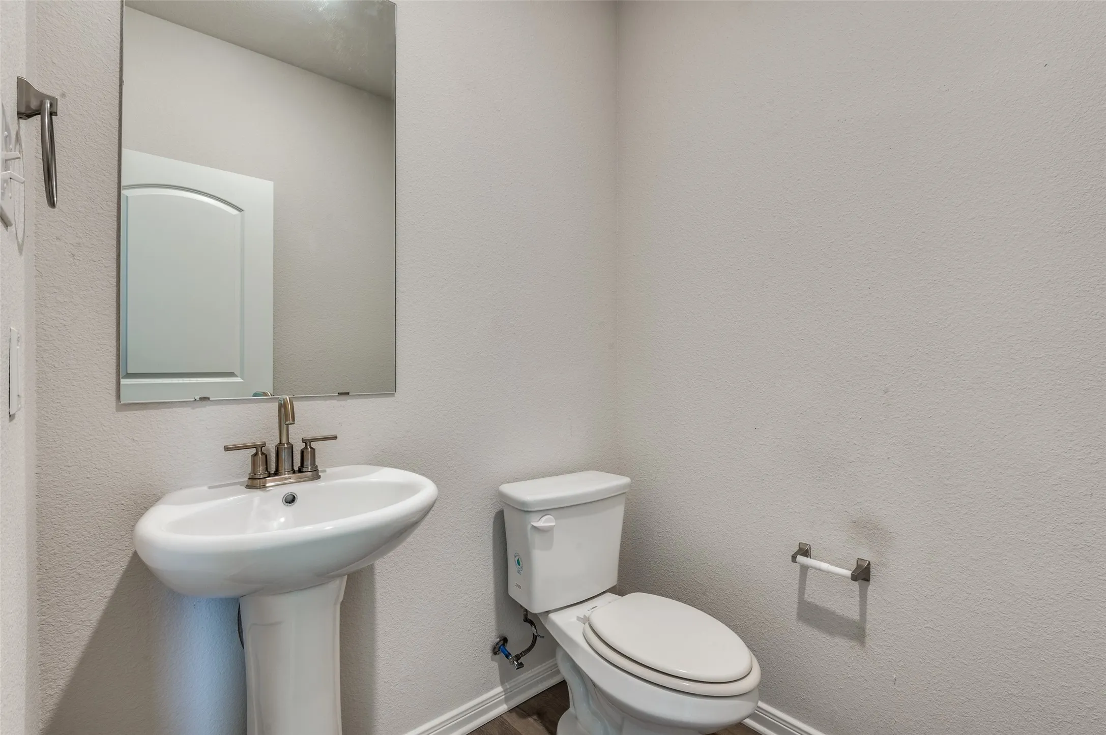 Half bathroom with a textured wall