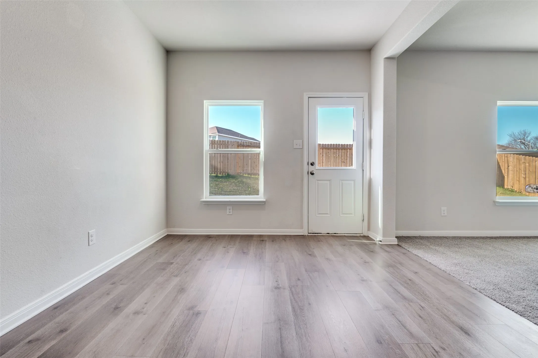 Foyer featuring baseboards and light wood-style floors