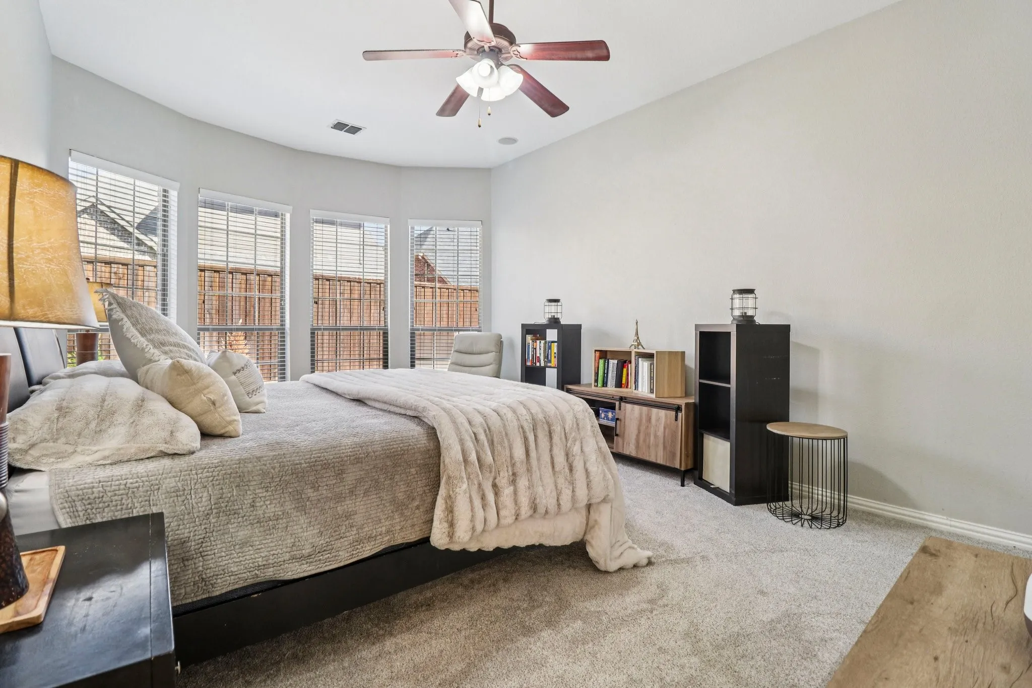 Carpeted bedroom featuring baseboards and ceiling fan