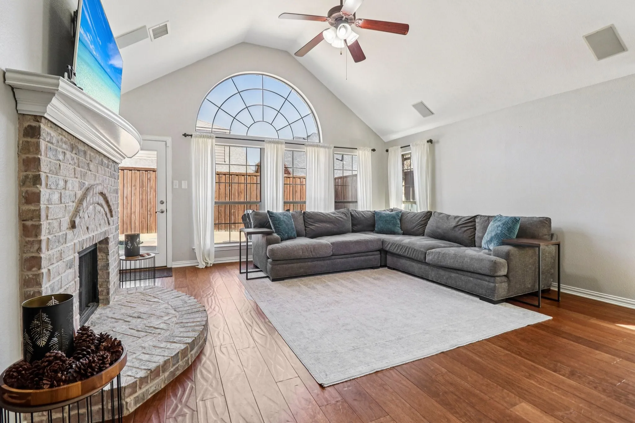 Living room that is accented by a cozy fireplace and natural light.