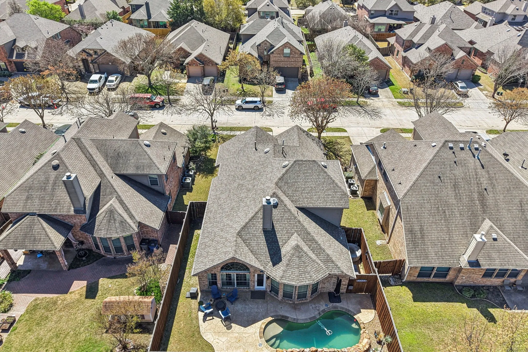 Aerial view of residential area featuring a pool.  Here you can see the side yard which is perfect for pets.