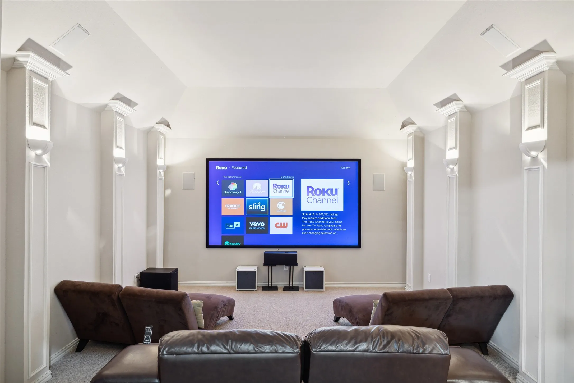 Large media room with 4K projector and screen, recliners and chaise lounge chairs