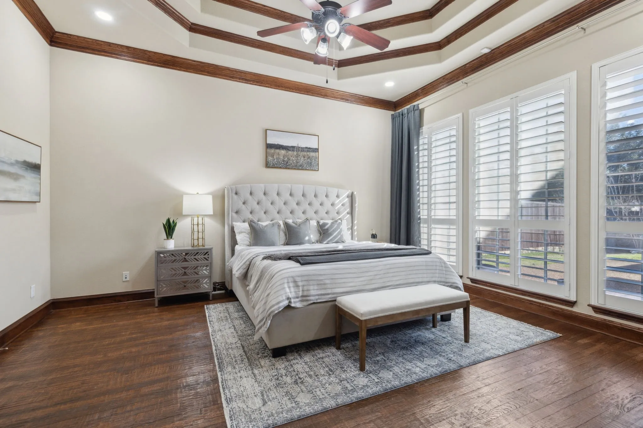 Large primary bedroom with backyard view