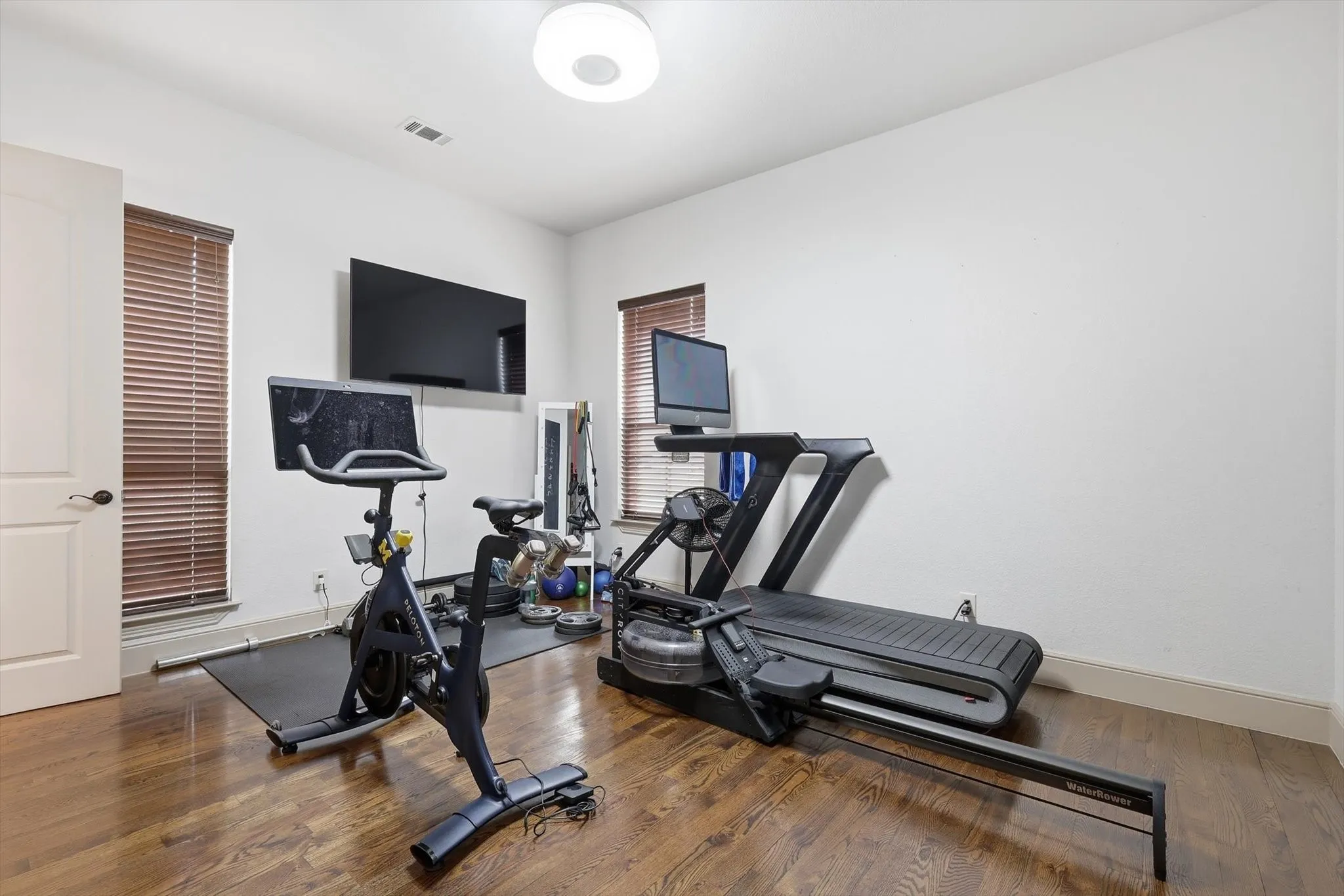 Workout area featuring wood finished floors and baseboards