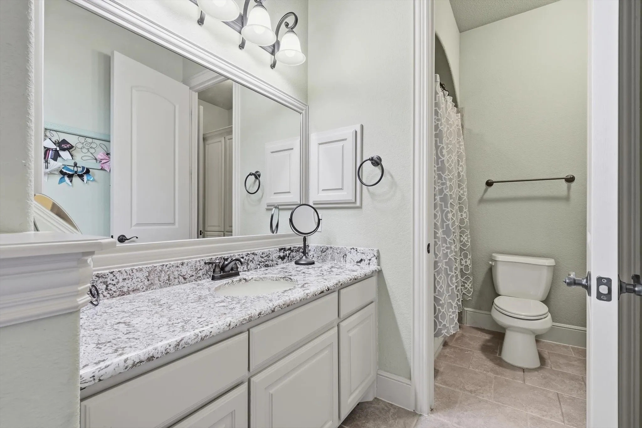 Full bath with vanity and a shower with shower curtain