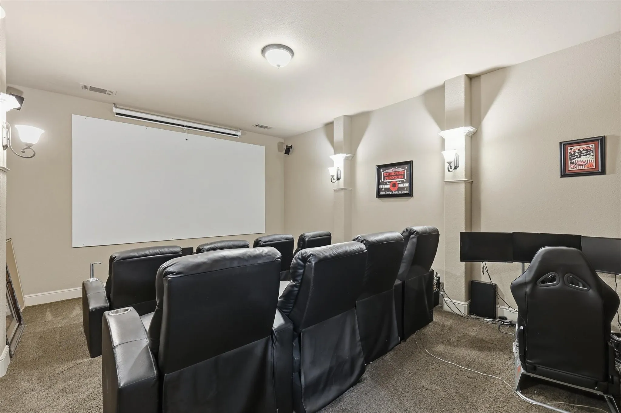 Home theater featuring carpet flooring and baseboards