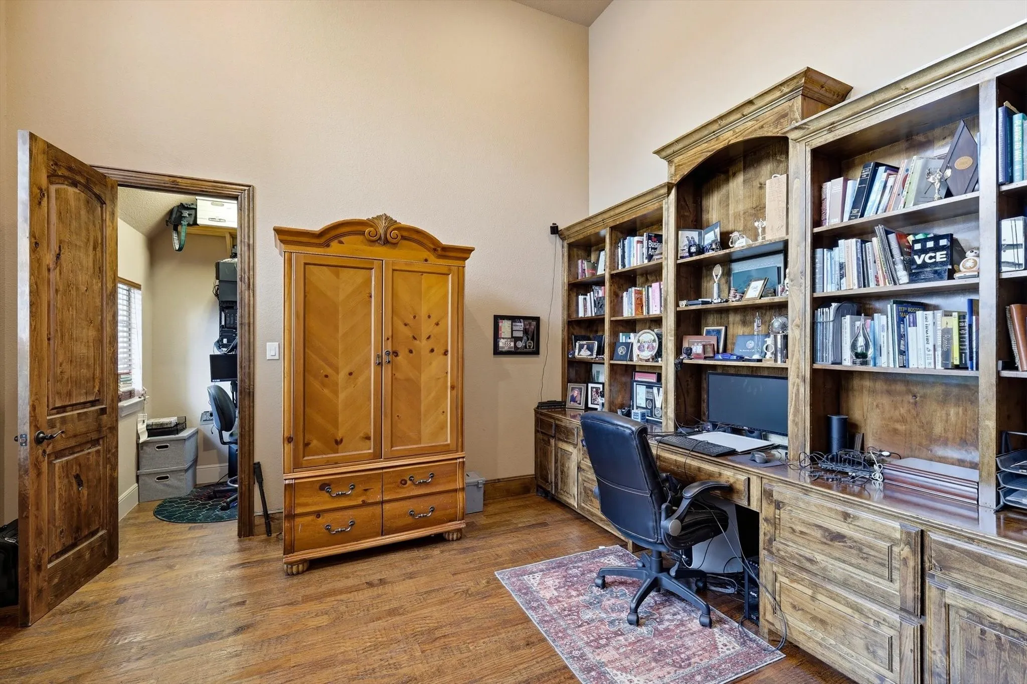 Home office featuring dark wood-type flooring and built in study area