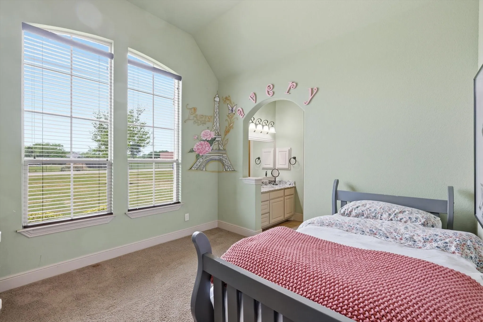 Bedroom featuring vaulted ceiling and light colored carpet
