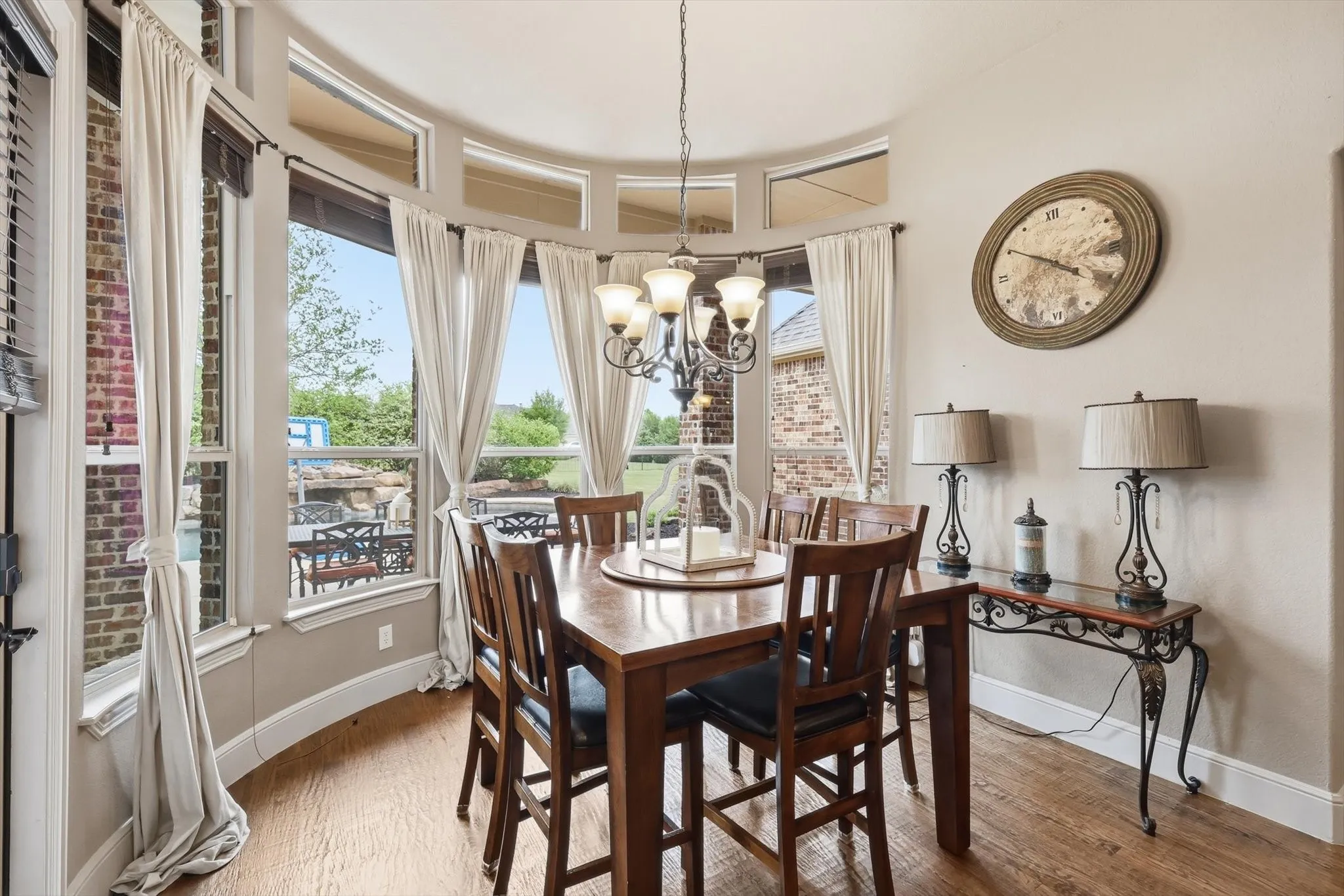 Dining room with light wood-style flooring and suspended lighting