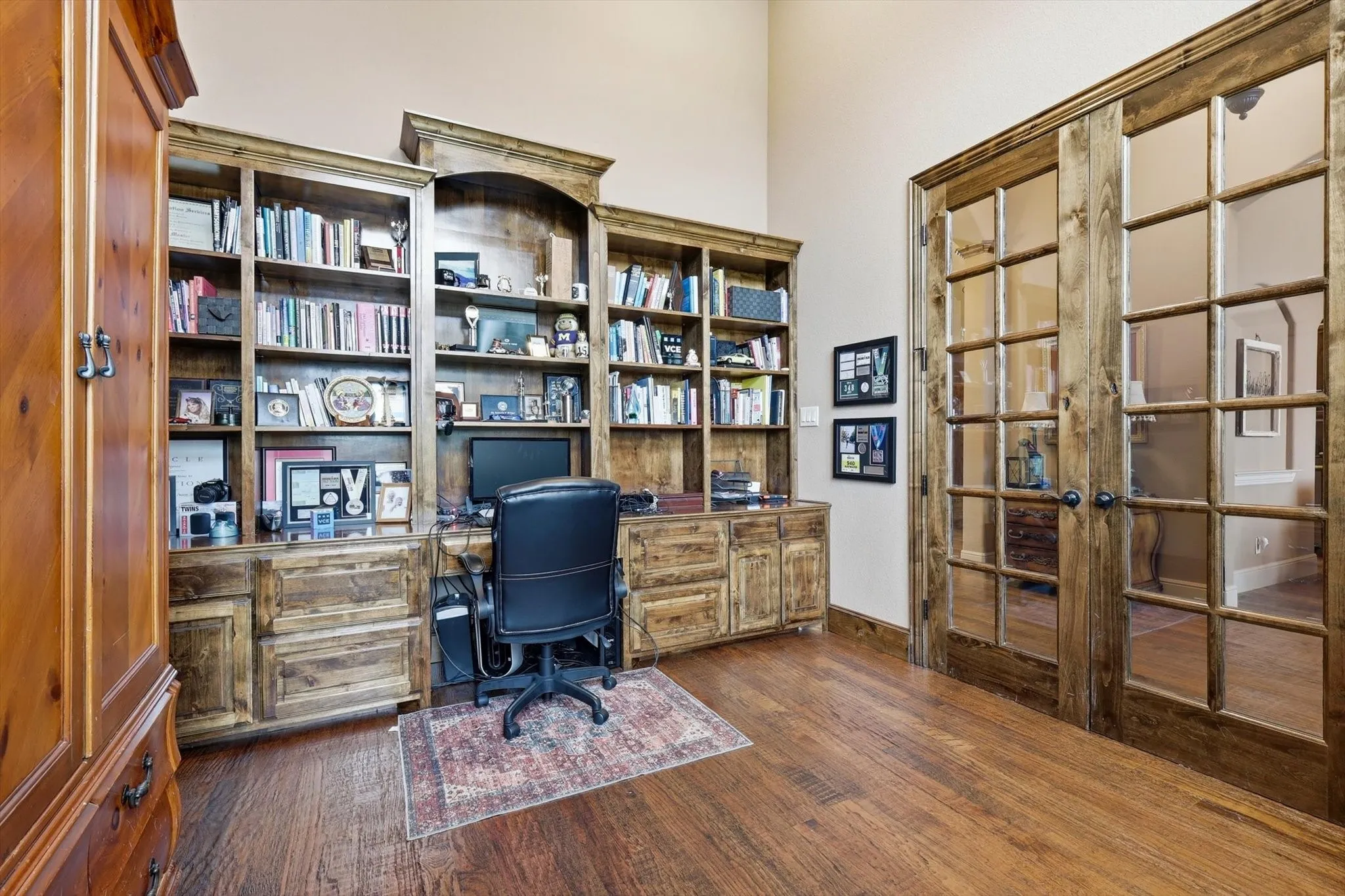 Home office featuring dark wood-style floors and french doors