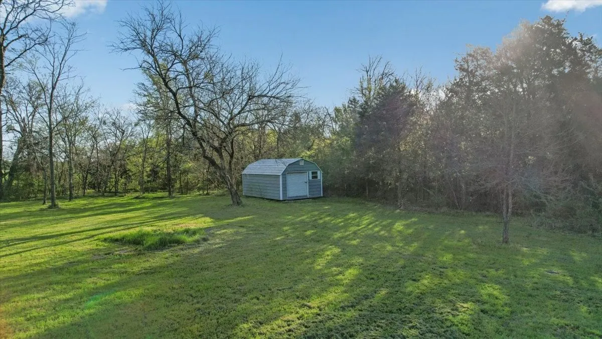 Open area for home site; storage building conveys with sale