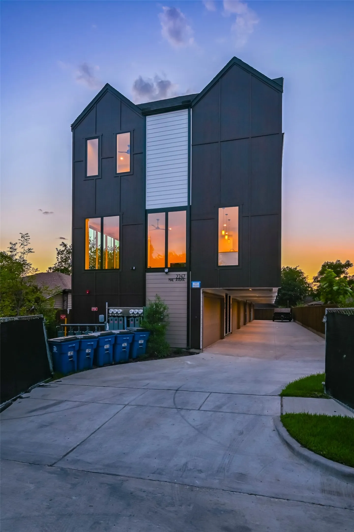 Modern multi-story facade featuring dark paneling and white horizontal siding