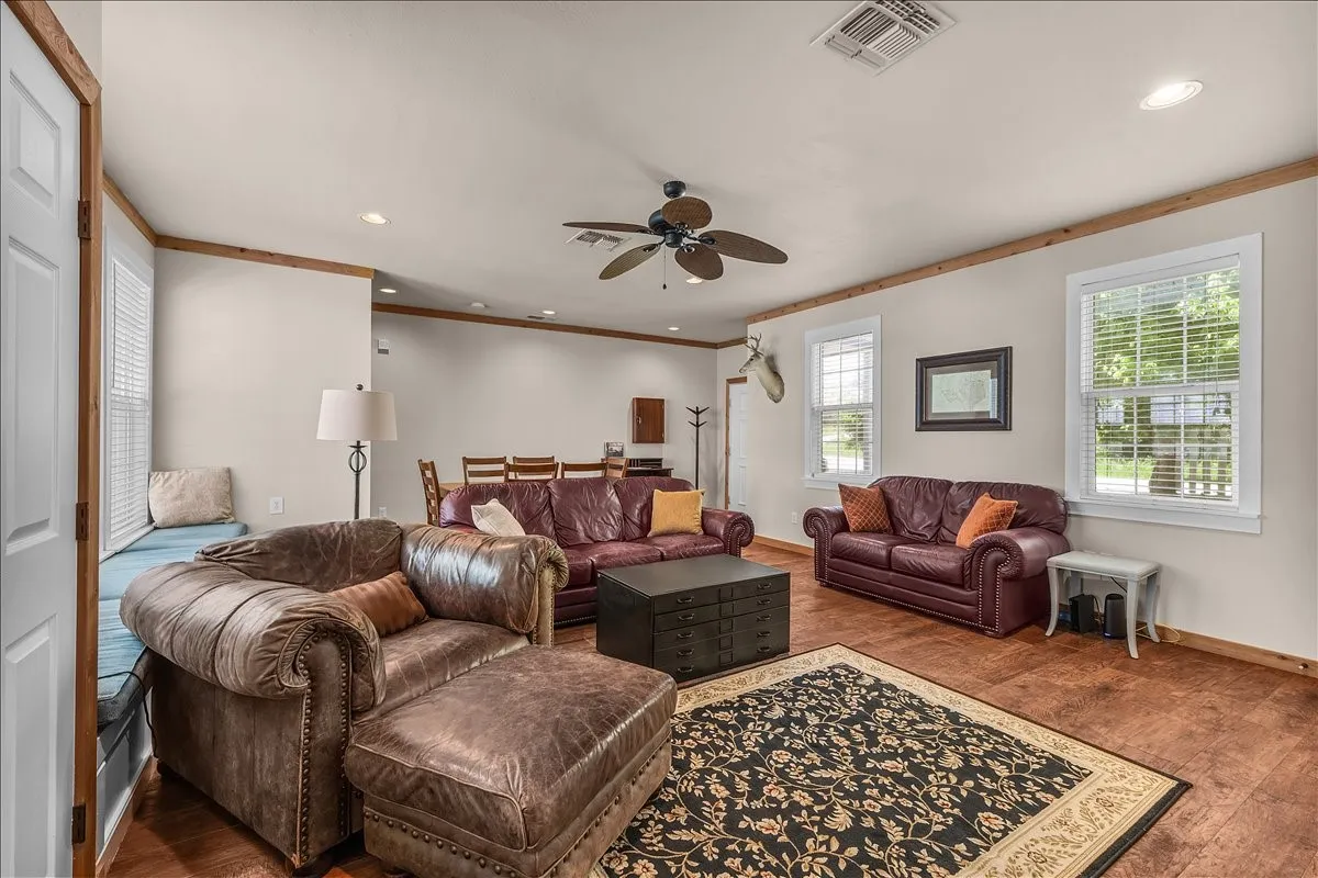 Living room with hardwood / wood-style flooring, recessed lighting, a ceiling fan, and ornamental molding