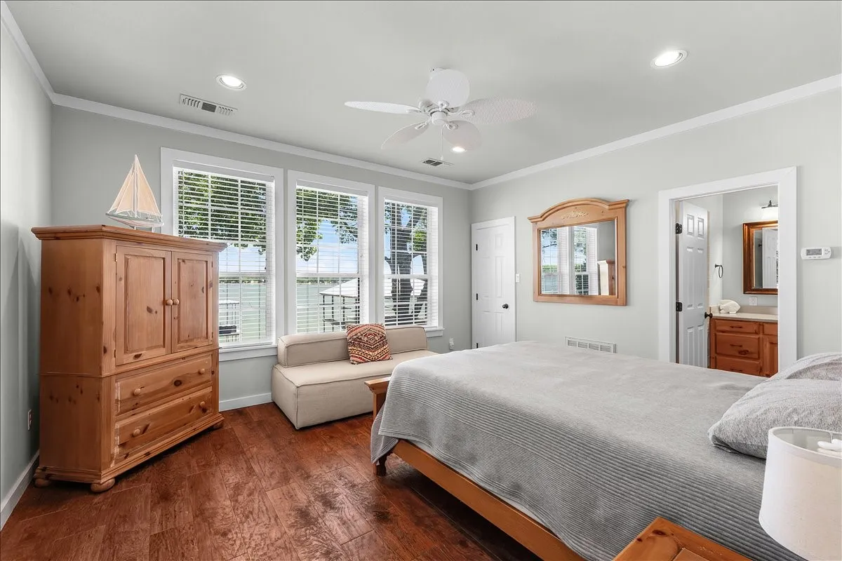Bedroom with dark wood-style flooring, recessed lighting, ornamental molding, a ceiling fan, and ensuite bathroom