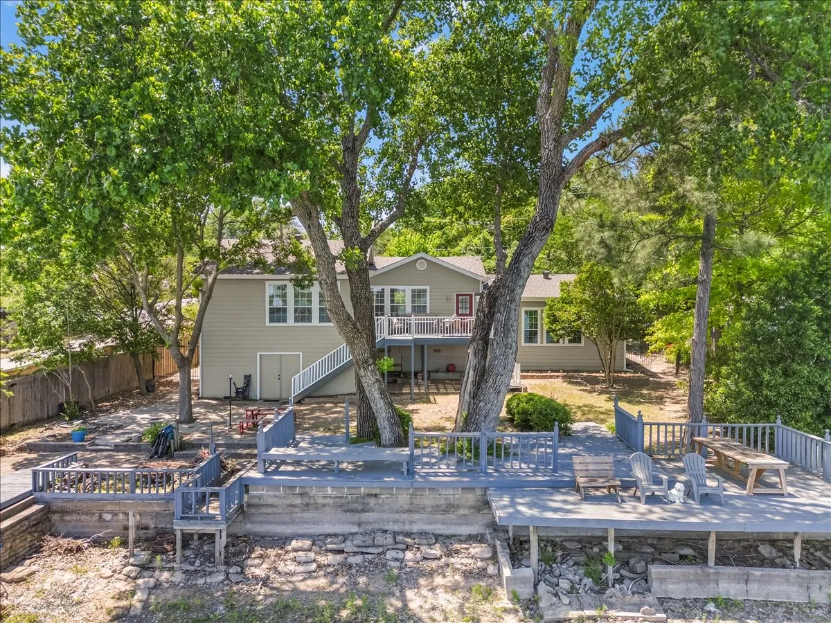 Back of property featuring a deck and a patio area