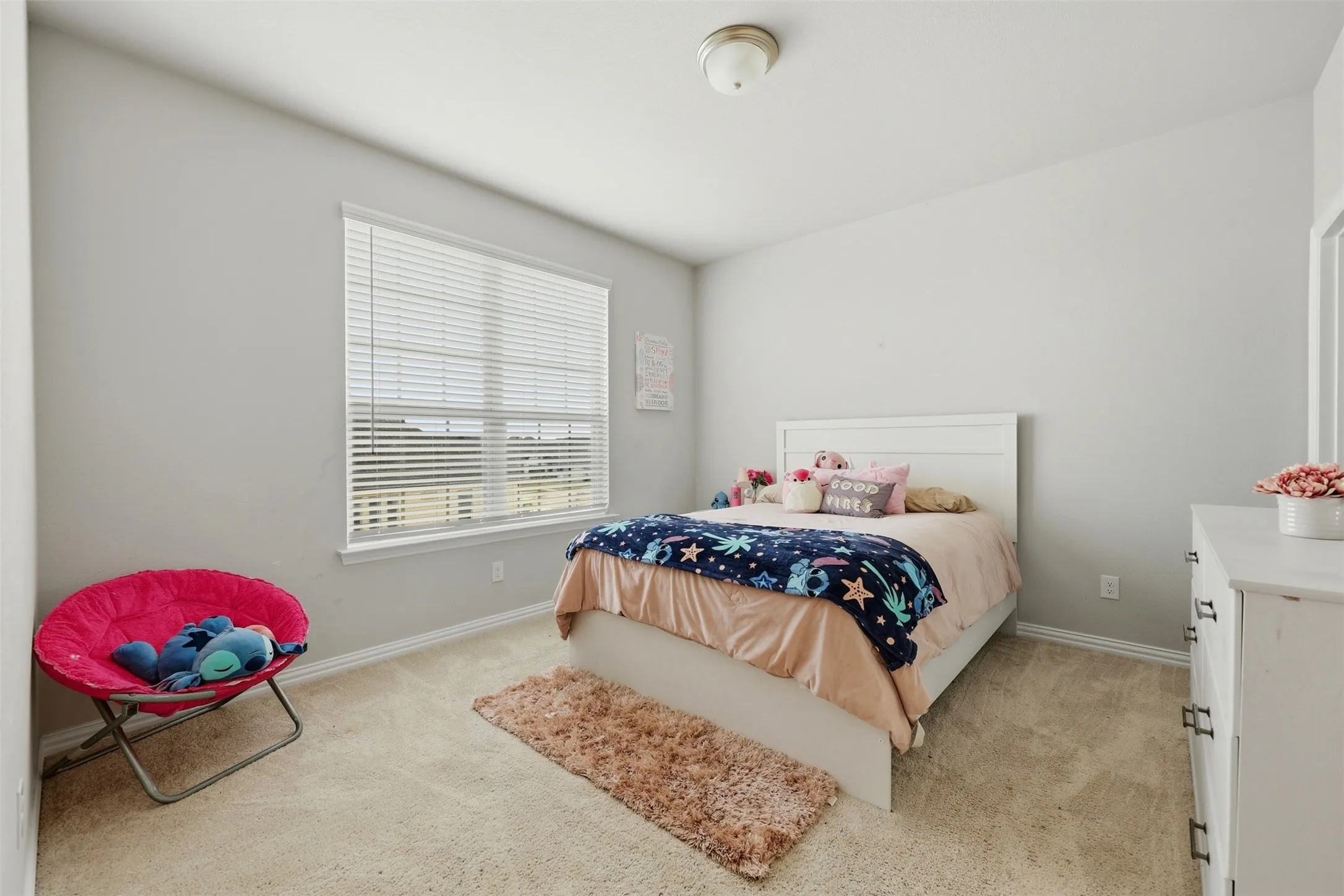 Bedroom featuring baseboards and light carpet