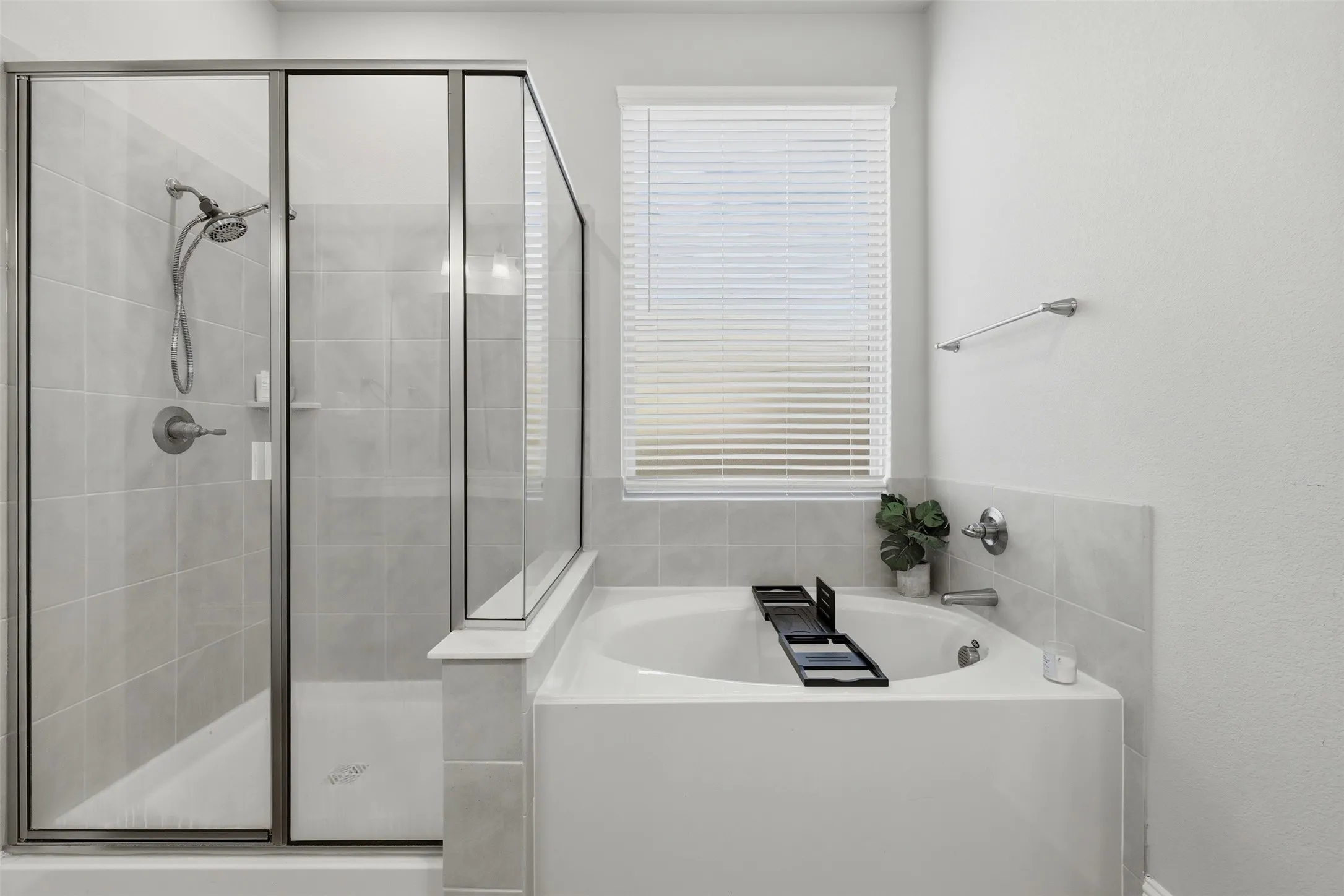 Bathroom featuring a garden tub and a shower stall