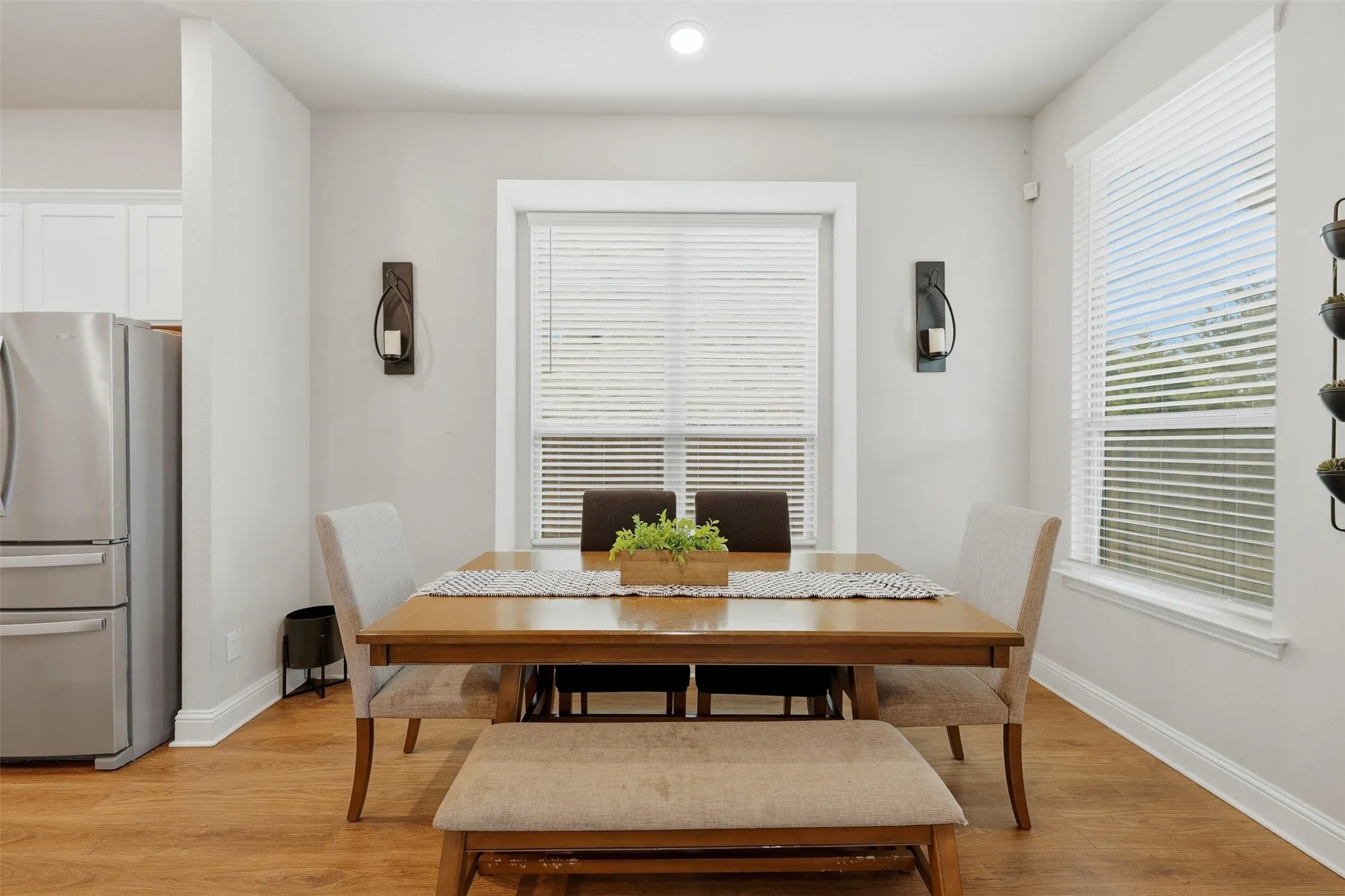 Dining area featuring light wood finished floors and recessed lighting