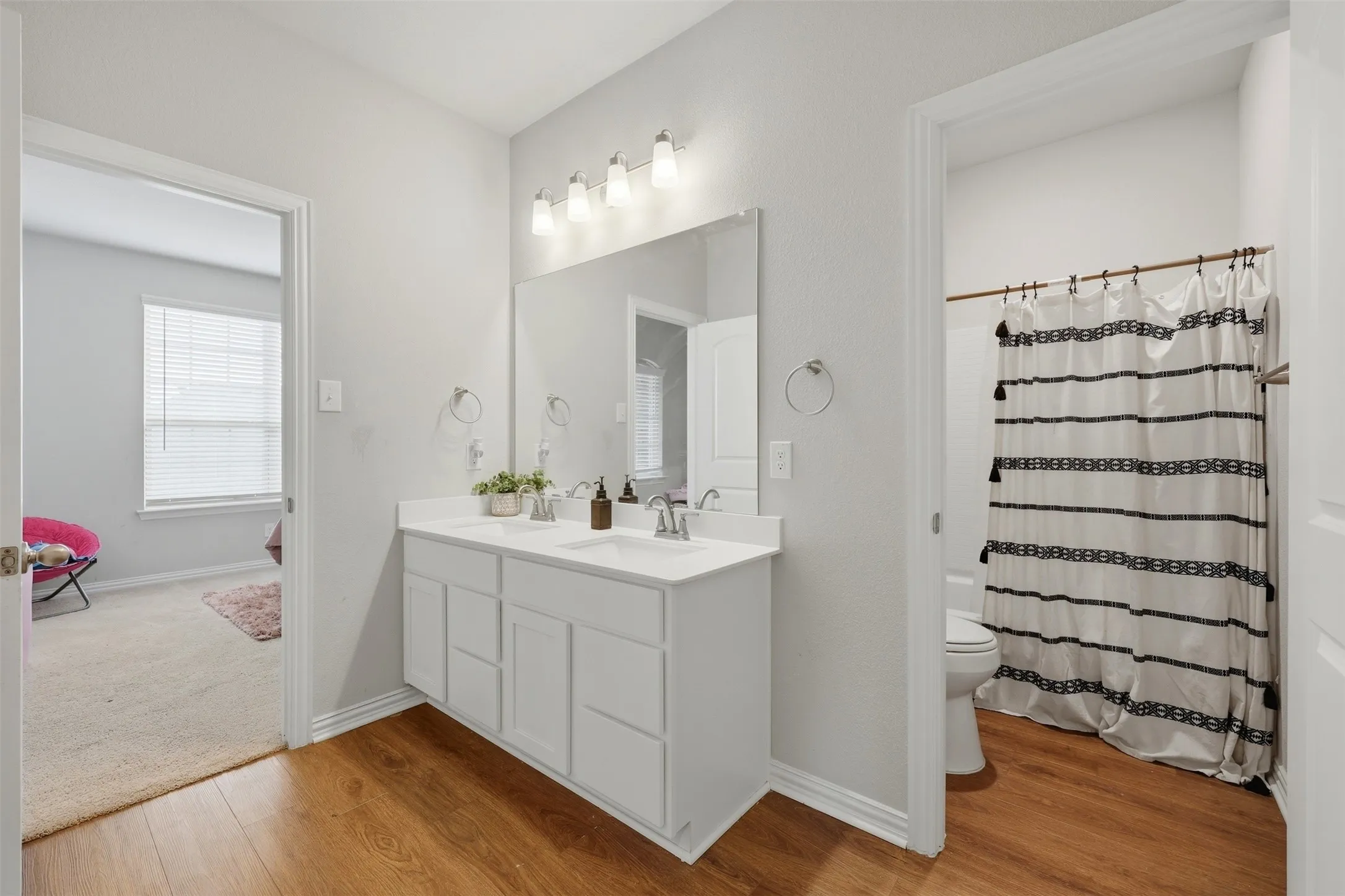 Full bath featuring vanity and light wood finished floors