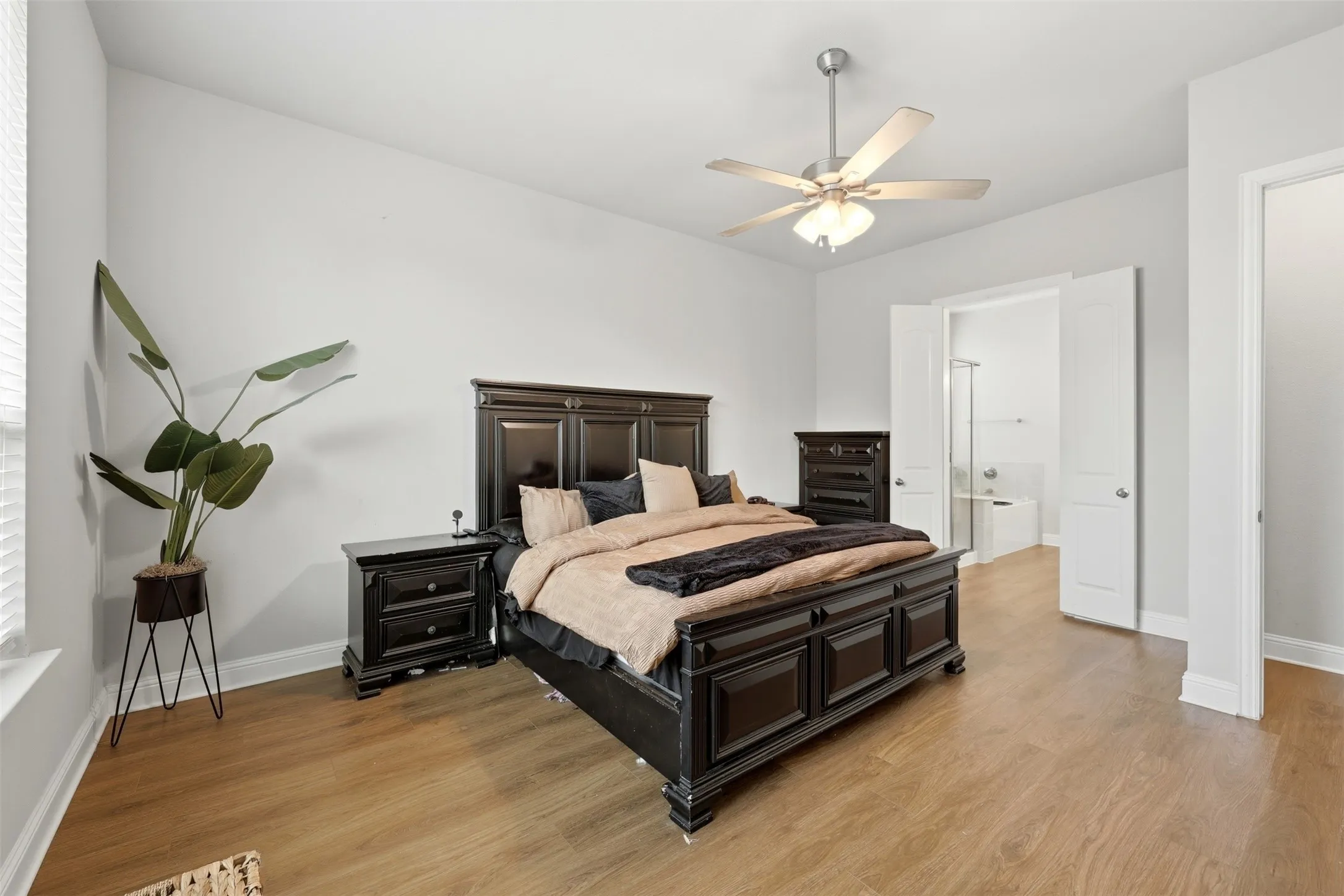 Bedroom with light wood-style floors and ceiling fan