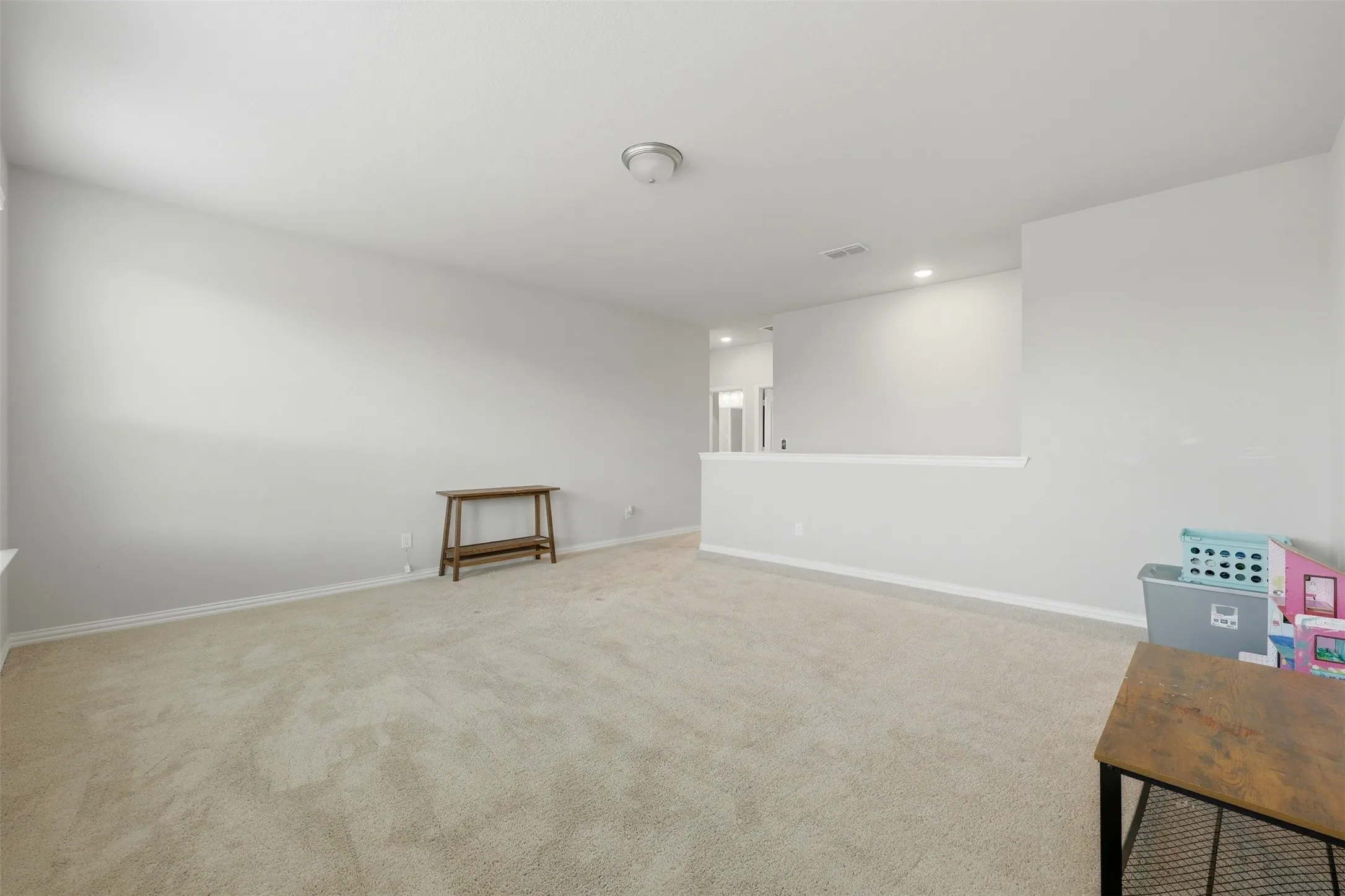 Spare room featuring carpet and recessed lighting